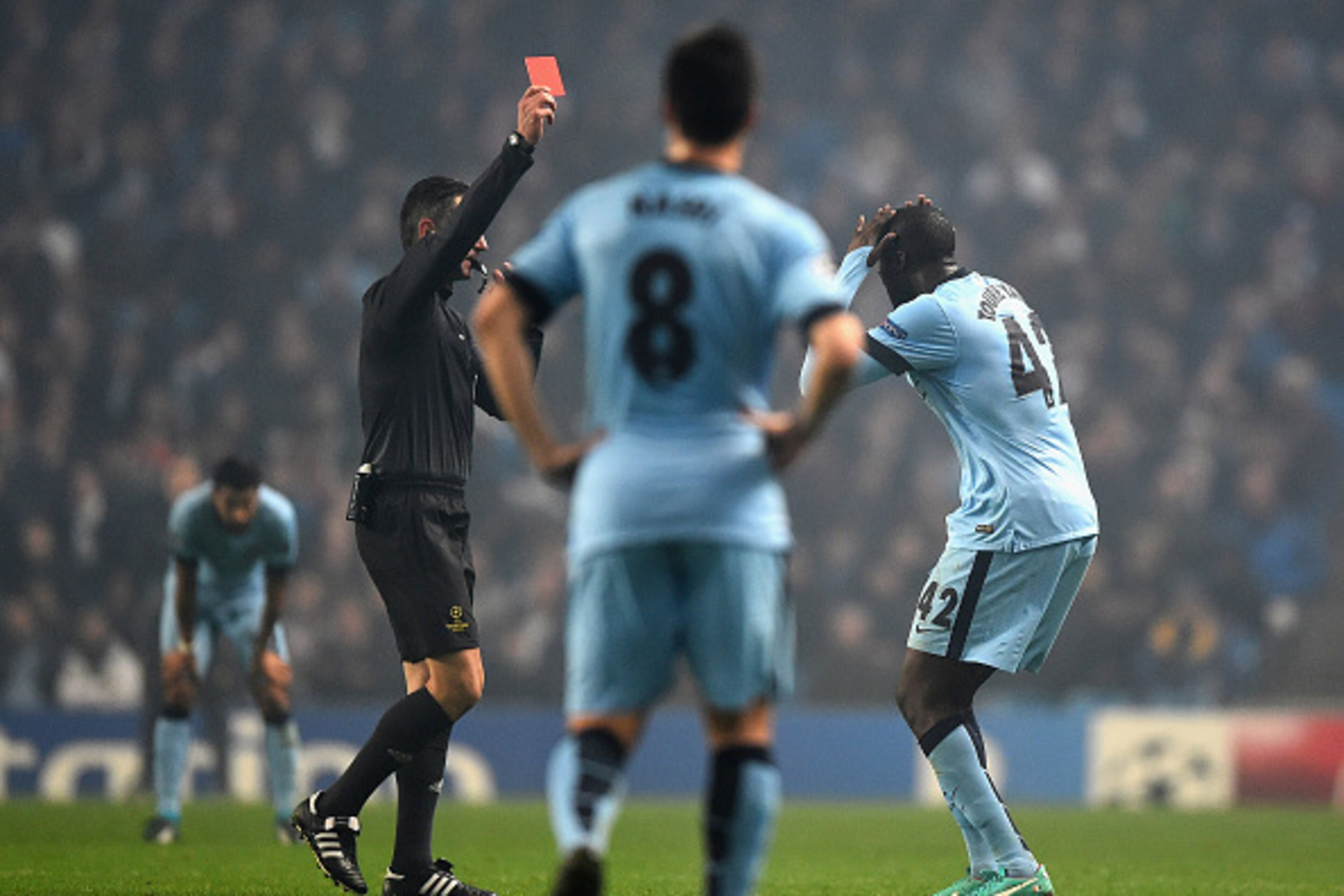 This image is perfect -- Toure doing something dumb while Nasri stands there doing nothing.