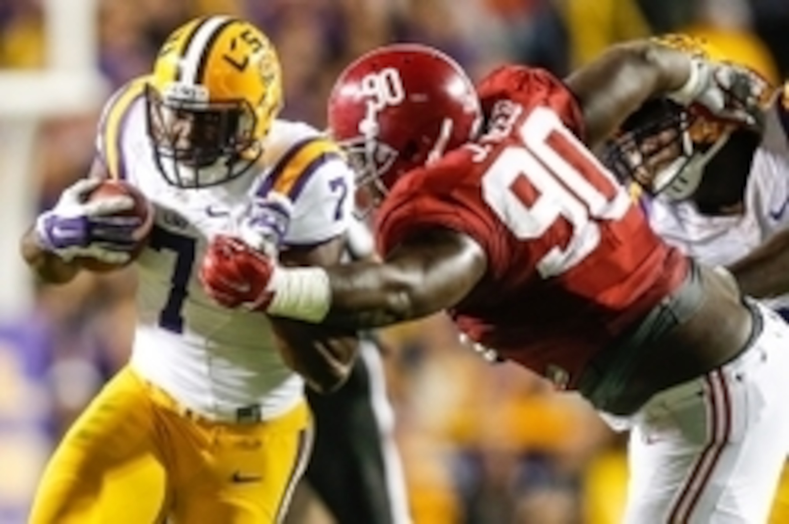 LSU running back Leonard Fournette (left) attempts to burst through the tackle of Alabama Jarran Reed.
