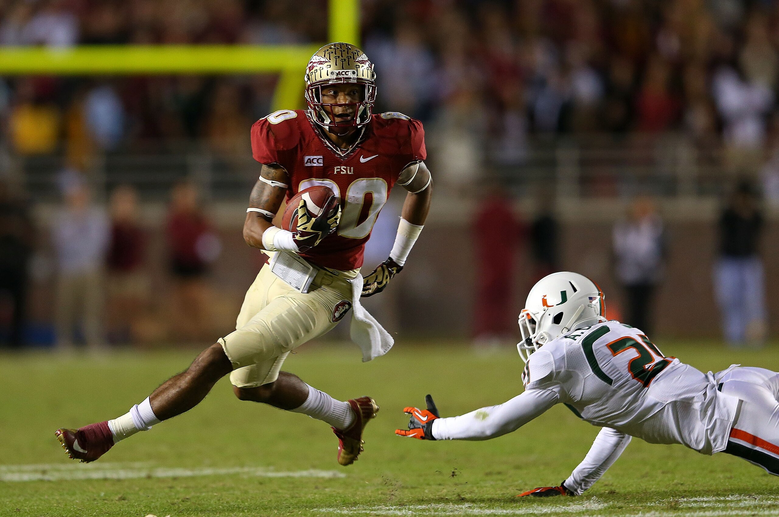 FSU's Rashad Greene hauls in a catch and slips past a Miami defender during the Seminoles' win in Tallahassee in 2013.
