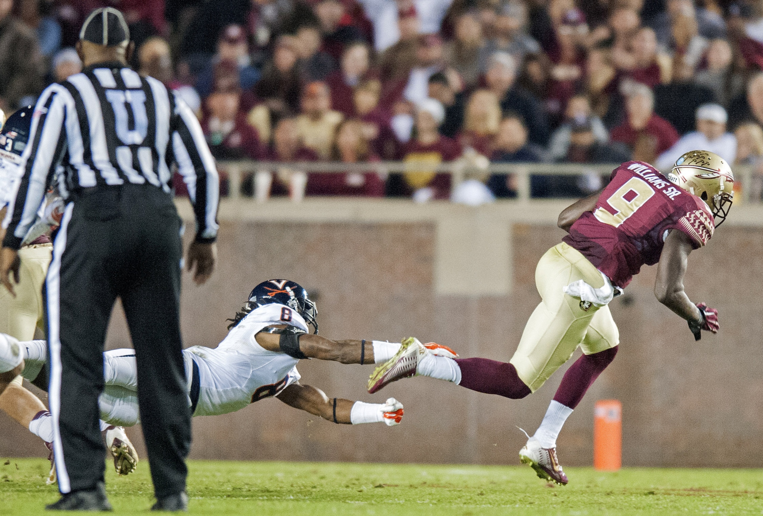 FSU senior Karlos Williams is tripped up on a play that would have gone for a long gain in Saturday's win over Virginia.