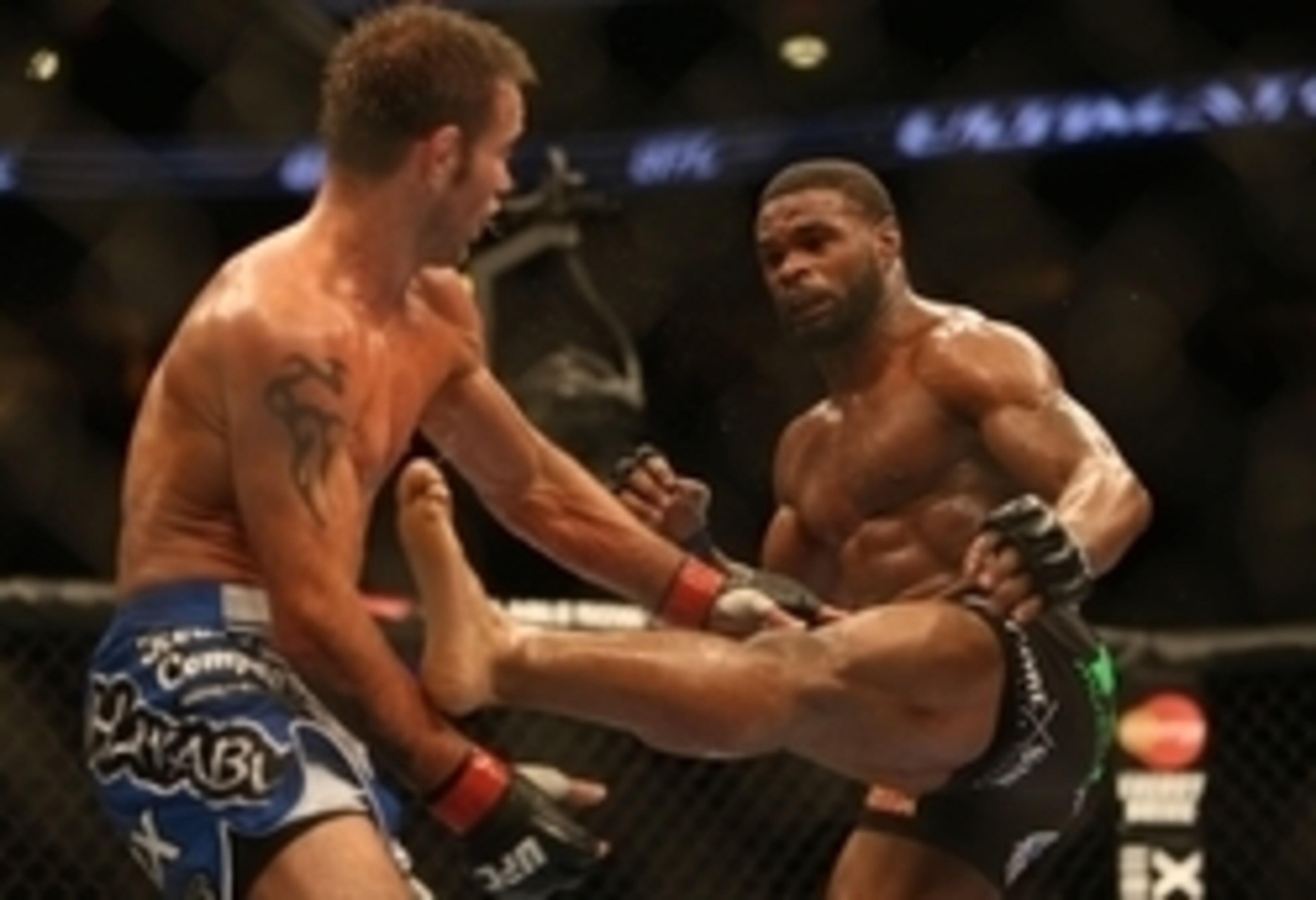Tyron Woodley hits Jake Shields with a left body kick at UFC 161.