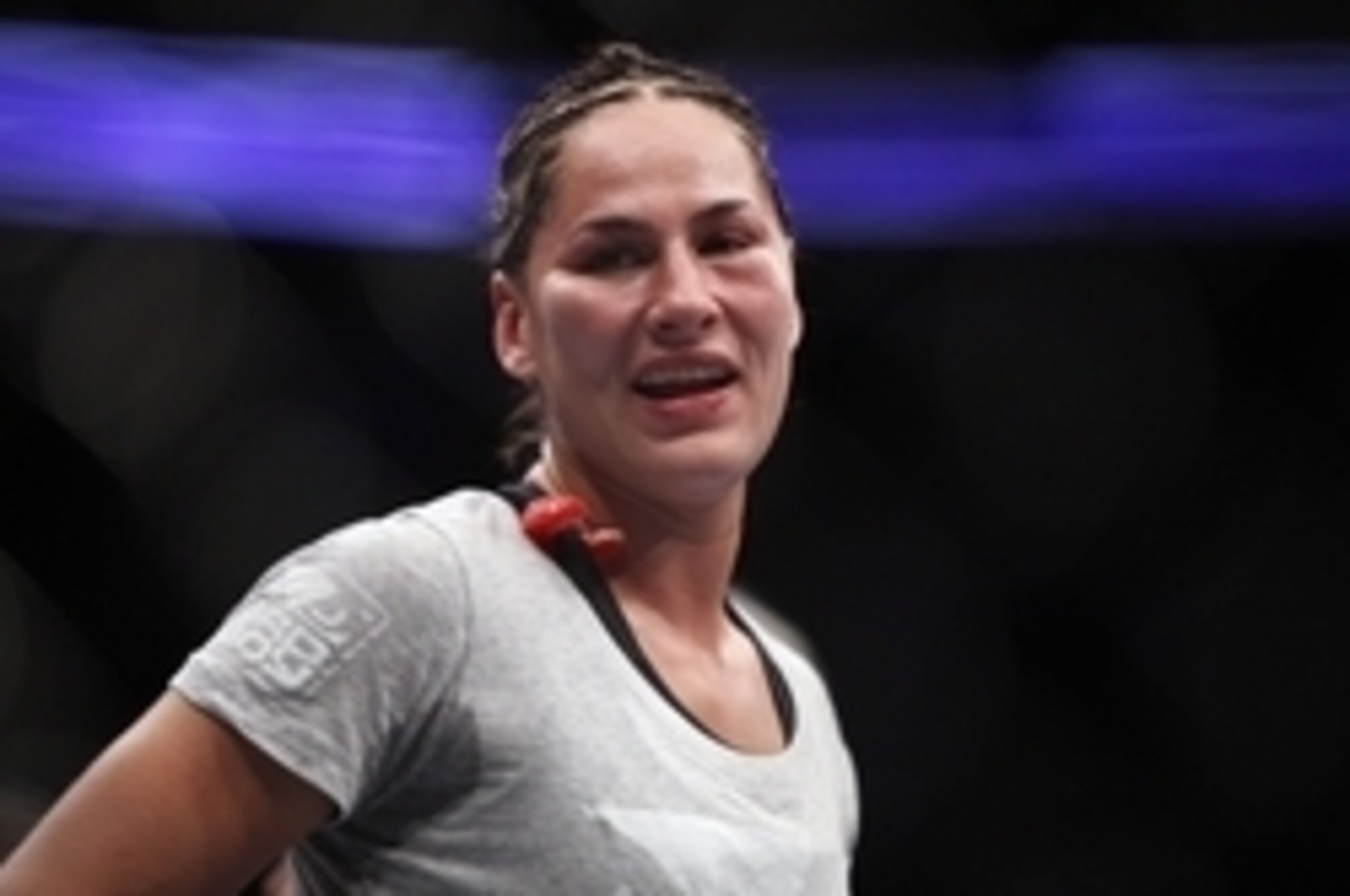 Oct 19, 2013; Houston, TX, USA; Jessica Eye (blue gloves) reacts after being defeated by decision by Sarah Kaufman (not pictured) in their women's bantamweight bout during UFC 166 at Toyota Center. Mandatory Credit: Andrew Richardson-USA TODAY Sports