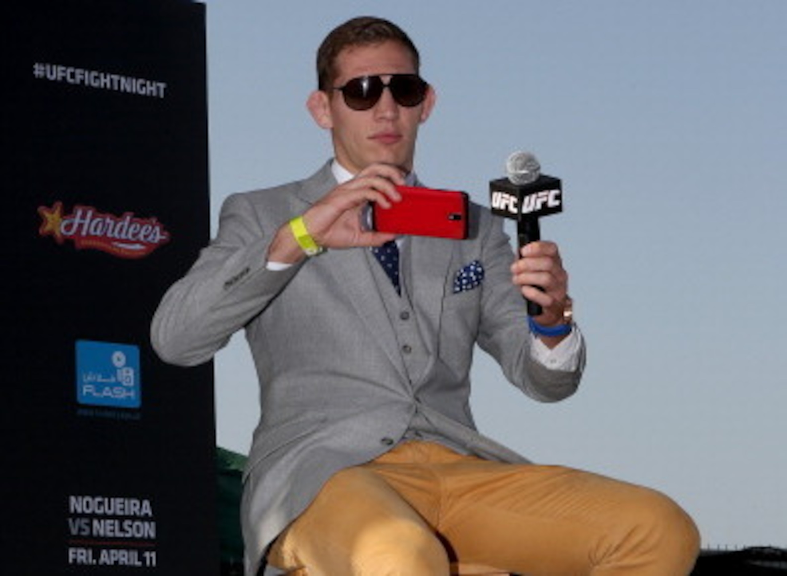 ABU DHABI, UNITED ARAB EMIRATES - APRIL 10:  UFC fighter Luke Barnatt takes a picture of the crowd as he answers questions during a Q&A after the weighs-in for UFC Fight Night 39 on April 10, 2014 in Abu Dhabi, United Arab Emirates. UFC Fight Night 39 wil