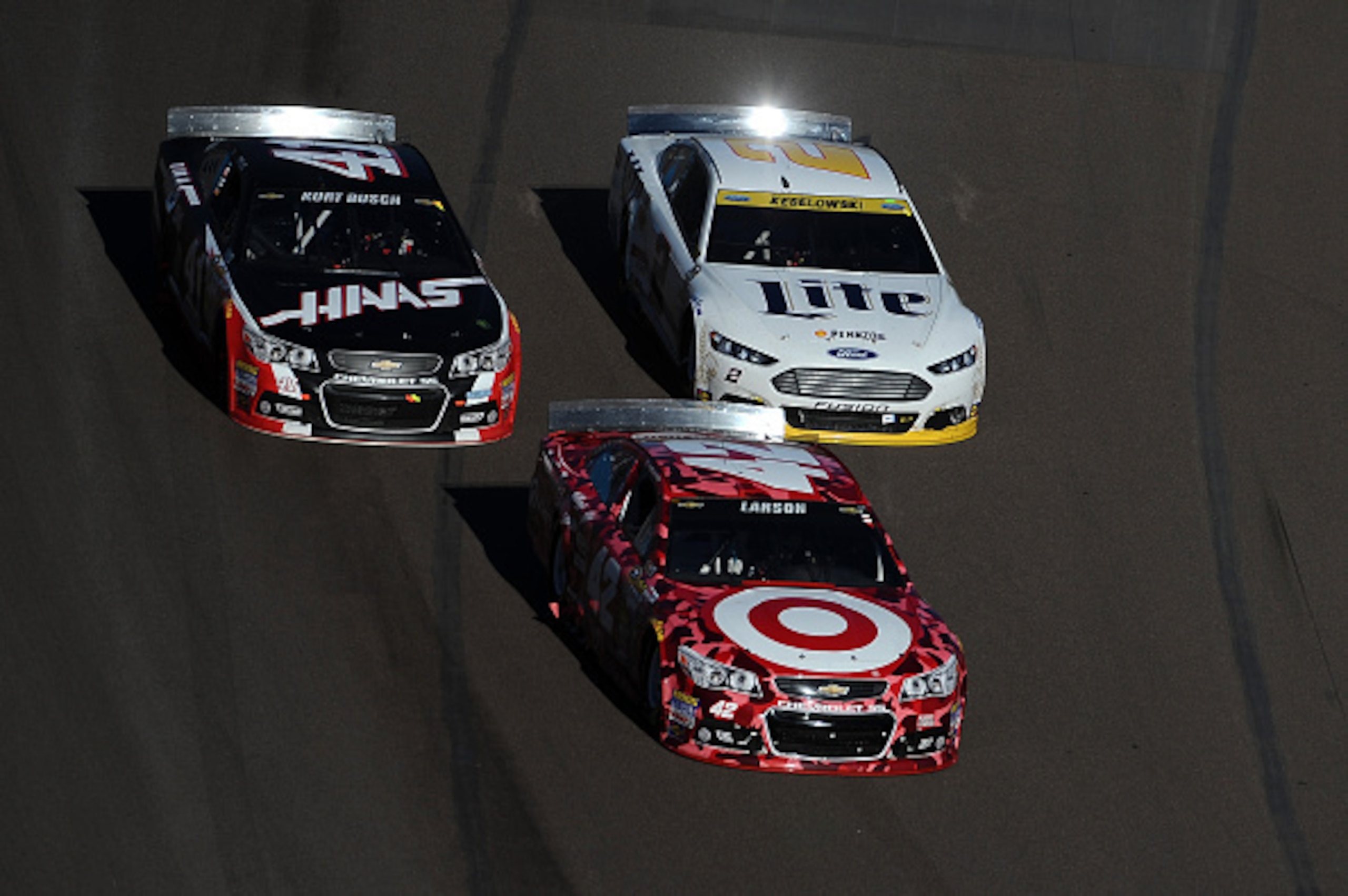 AVONDALE, AZ - NOVEMBER 09: Kyle Larson, driver of the #42 Target Chevrolet, leads Brad Keselowski, driver of the #2 Miller Lite Ford, and Kurt Busch, driver of the #41 Haas Automation Chevrolet, during the NASCAR Sprint Cup Series Quicken Loans Race for 