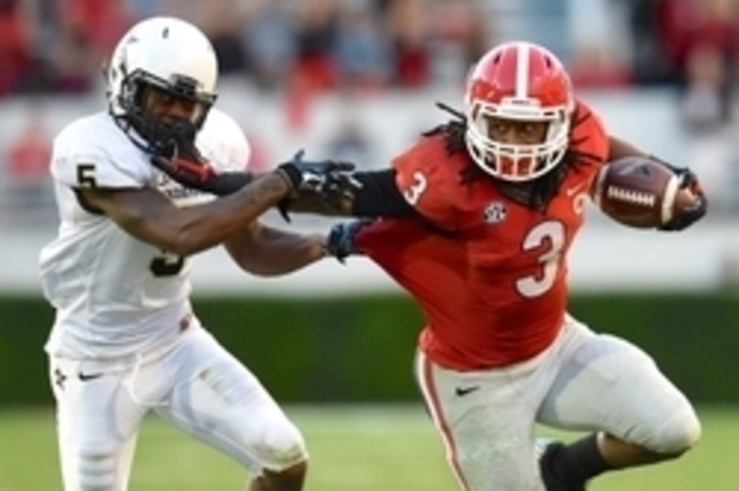 Oct 4, 2014; Athens, GA, USA; Georgia Bulldogs running back Todd Gurley (3) runs against Vanderbilt Commodores defensive back Torren McGaster (5) during the second half at Sanford Stadium. Georgia defeated Vanderbilt 44-17. Mandatory Credit: Dale Zanine-U