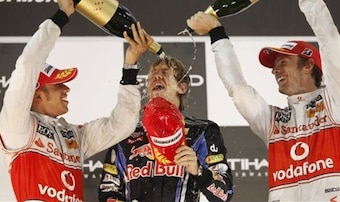 Sebastian Vettel celebrates his first title with the help of Lewis Hamilton and Jenson Button.