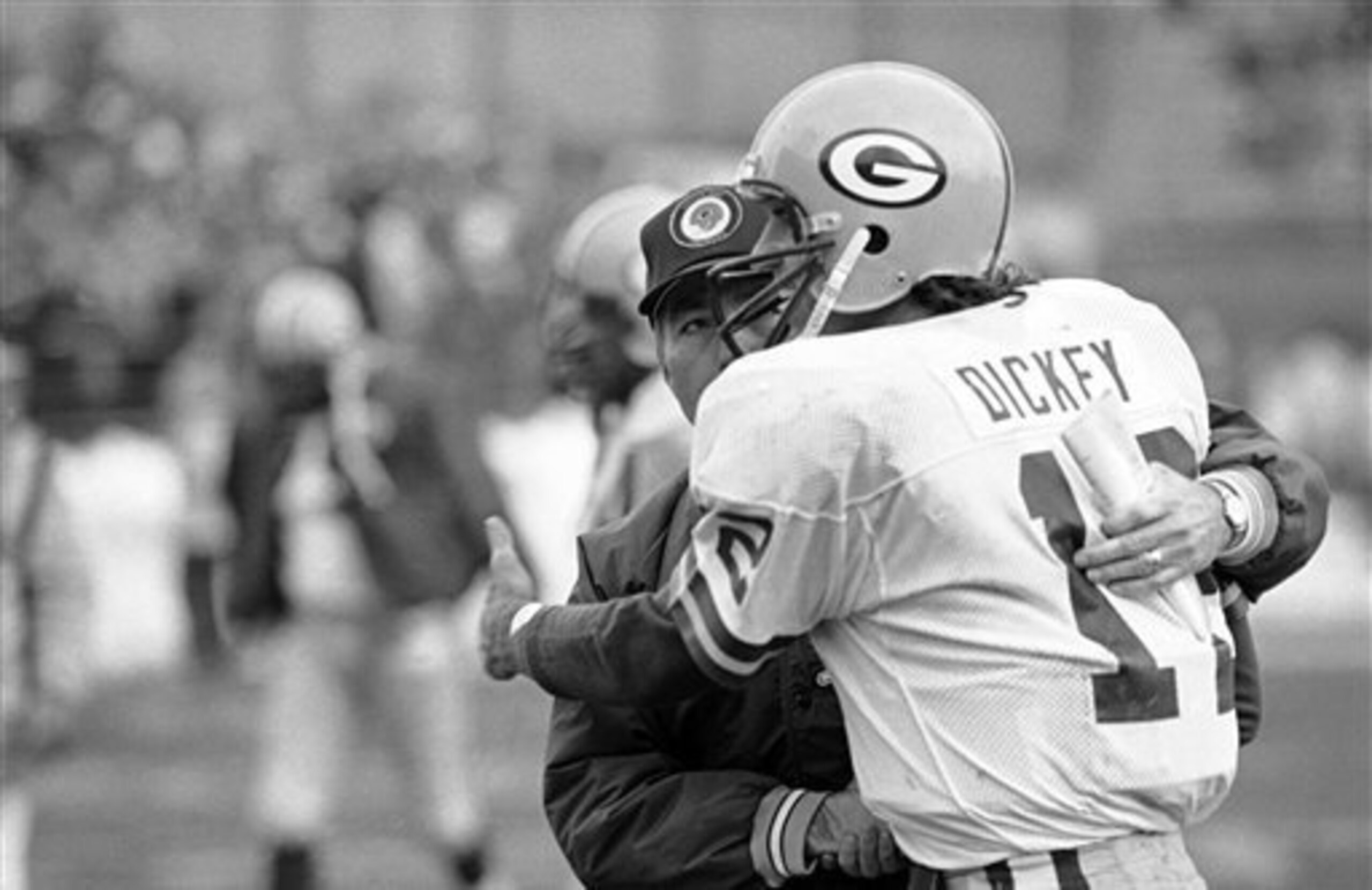 Bart Starr and Lynn Dickey embraced after a big win over the Vikings.