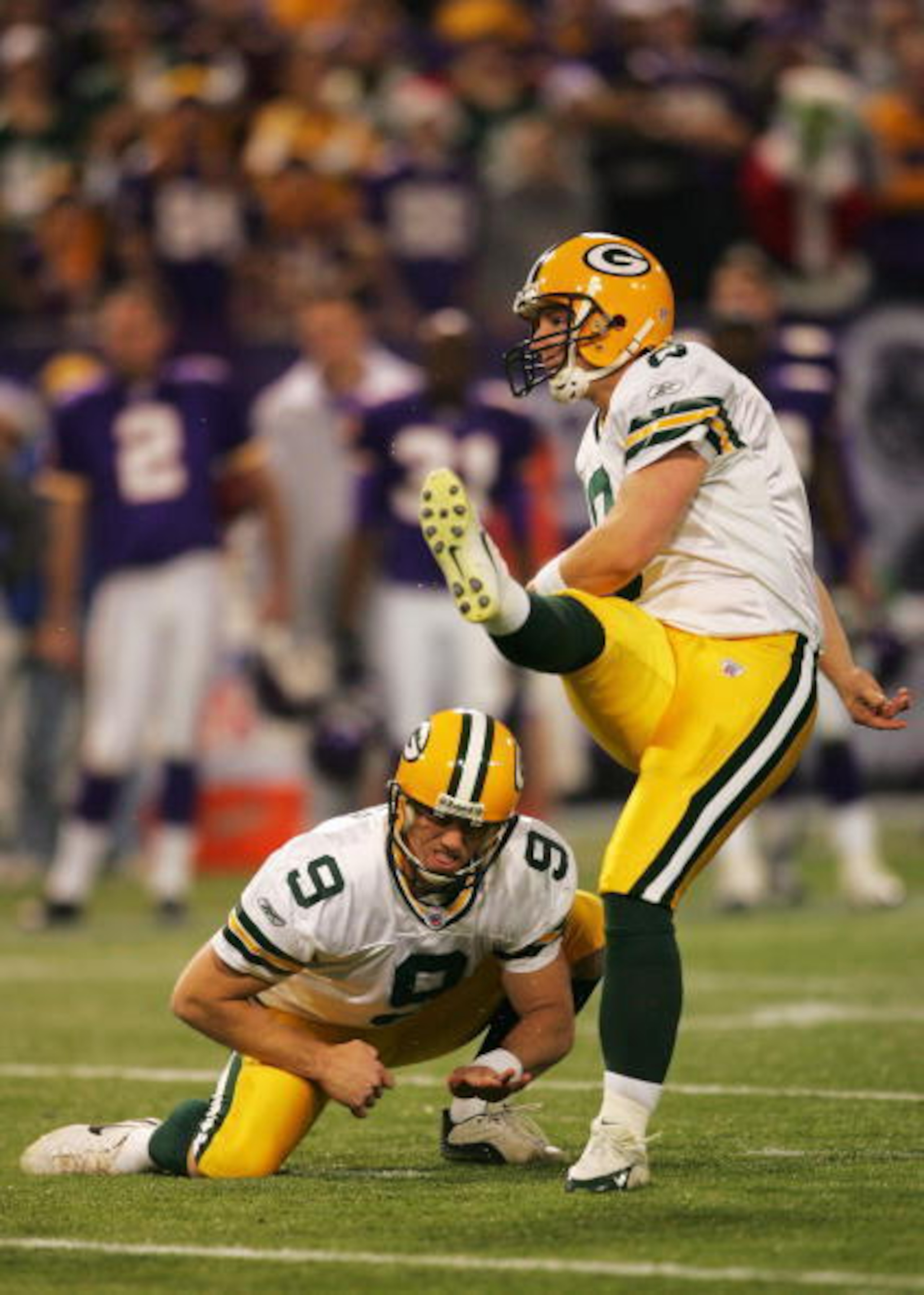 MINNEAPOLIS - DECEMBER 24:  Ryan Longwell #9 of the Green Bay Packers kicks a field goal to end the first half against the Minnesota Vikings December 24, 2004 at the Hubert H Humphrey Metrodome in Minneapolis, Minnesota. Bryan Barker #9 is the holder. (Ph