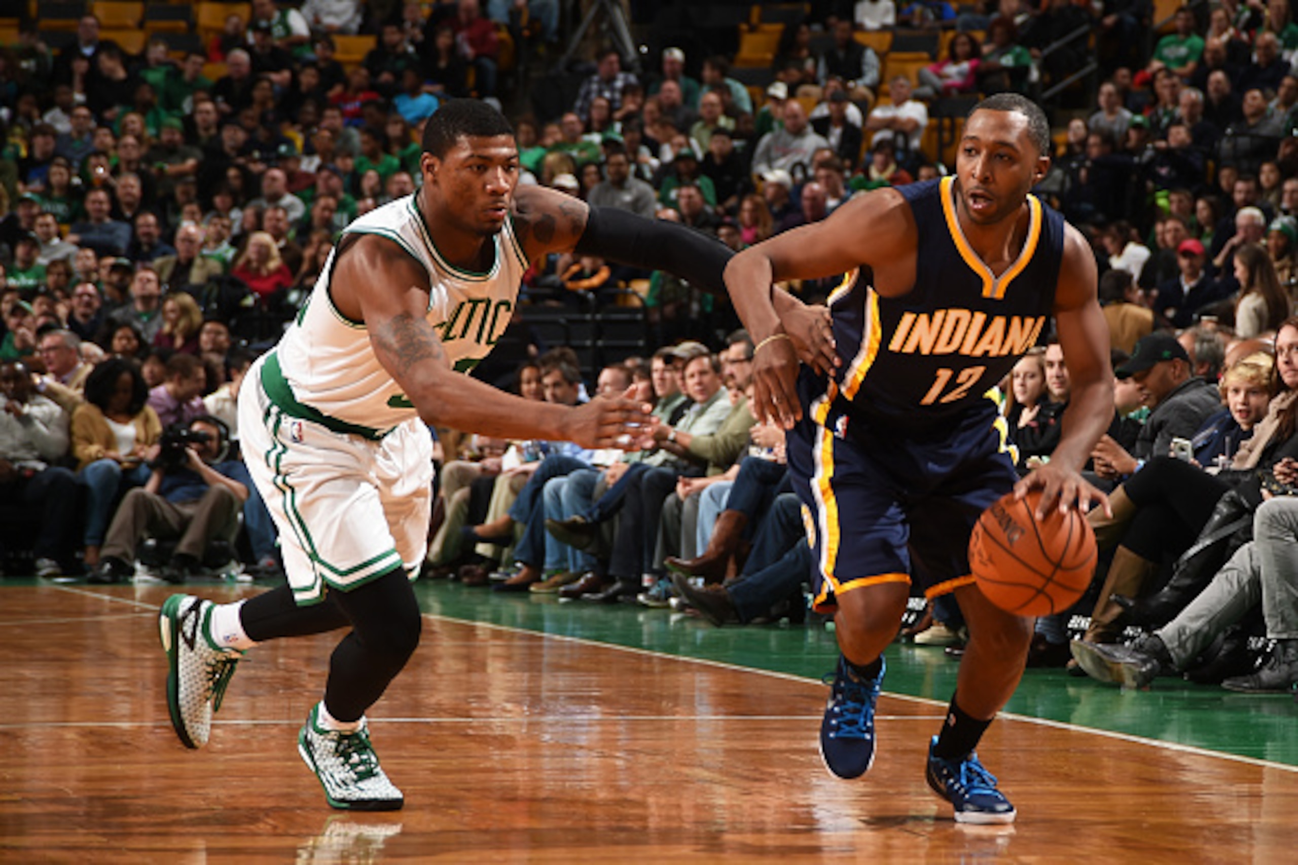 Indiana Pacers point guard A.J. Price (right) tries to get past Boston Celtics guard Marcus Smart.