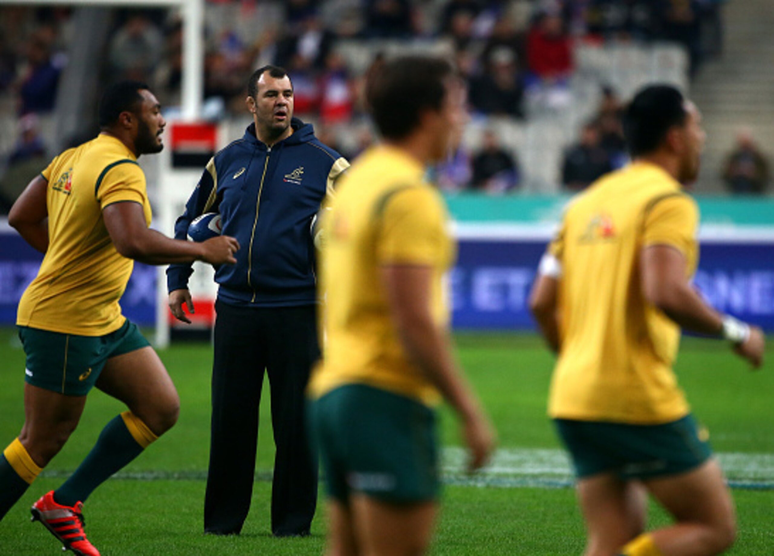 PARIS, FRANCE - NOVEMBER 15: Australia head coach Michael Cheika keeps an eye on the warm up during the International match between France and Australia at The Stade De France on November 15, 2014 in Paris, France. (Photo by Charlie Crowhurst/Getty Images