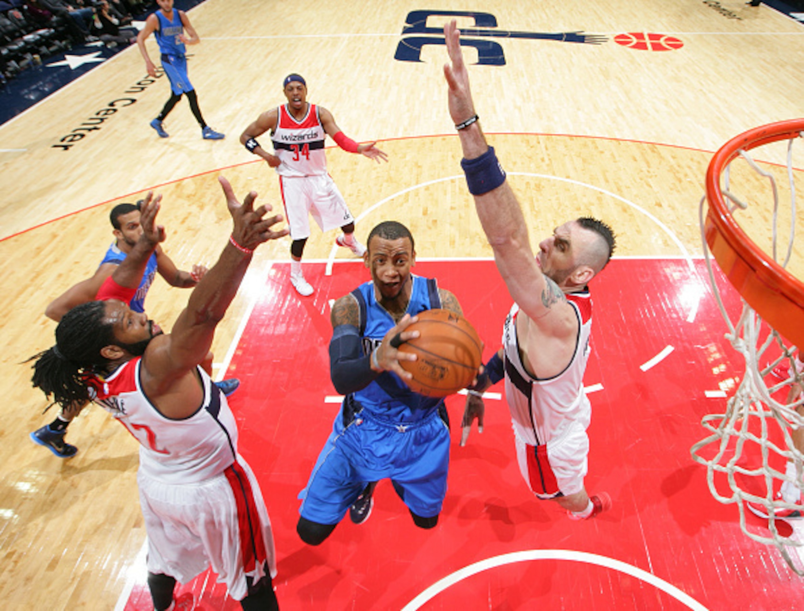 WASHINGTON, DC - NOVEMBER 19: Monta Ellis #11 of the Dallas Mavericks shoots against Marcin Gortat #4 and Nene #42 of the Washington Wizards during a game at the Verizon Center on November 19, 2014 in Washington, DC. NOTE TO USER: User expressly acknowled