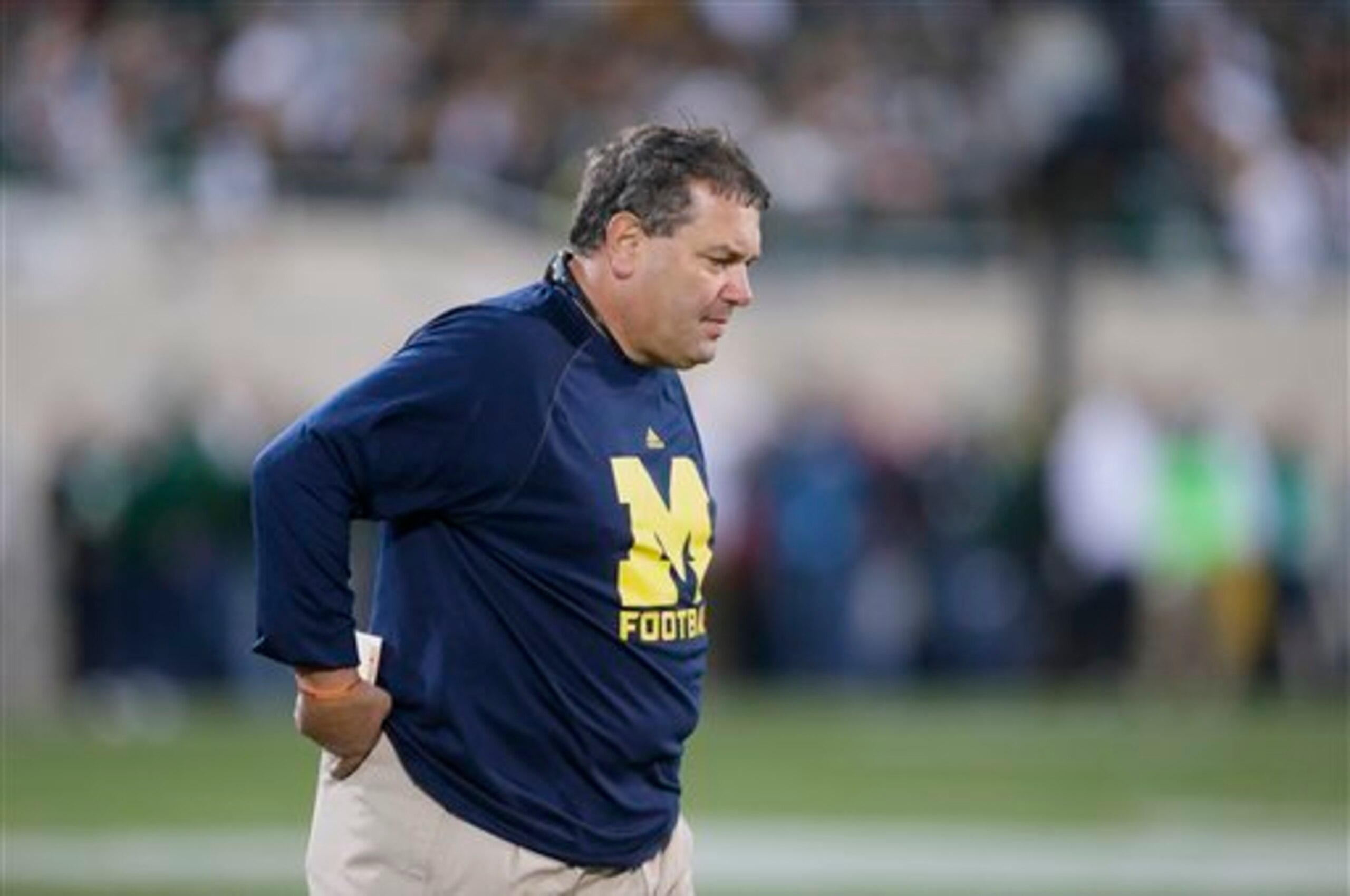 Michigan head coach Brady Hoke walks to the sidelines during the second half of an NCAA college football game against Michigan State in East Lansing, Mich., Saturday, Oct. 25, 2014. (AP Photo/Carlos Osorio)