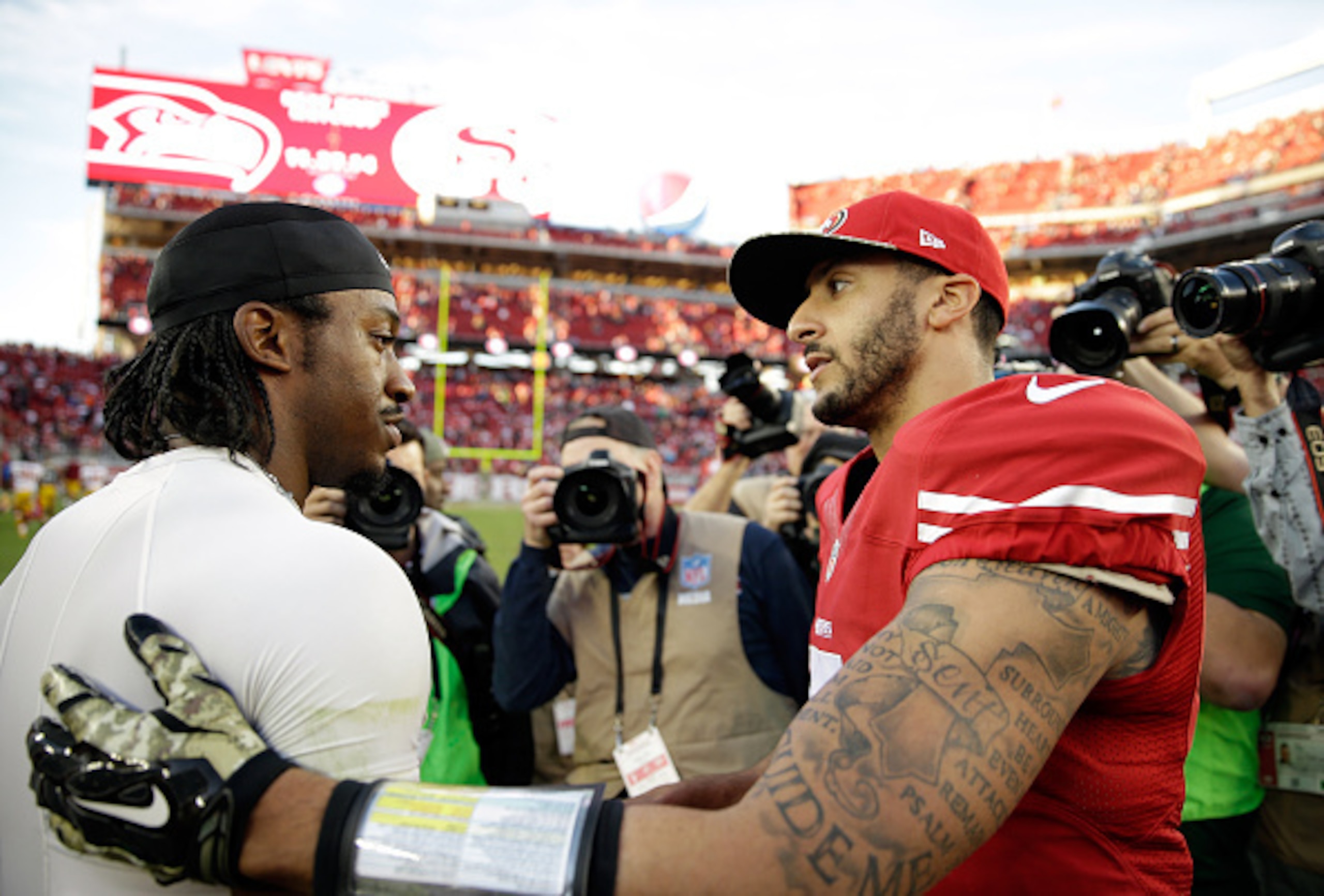 SANTA CLARA, CA - NOVEMBER 23: Colin Kaepernick #7 of the San Francisco 49ers speaks with Robert Griffin III #10 of the Washington Redskins at the conclusion of their game at Levi's Stadium on November 23, 2014 in Santa Clara, California.  (Photo by Ezra 