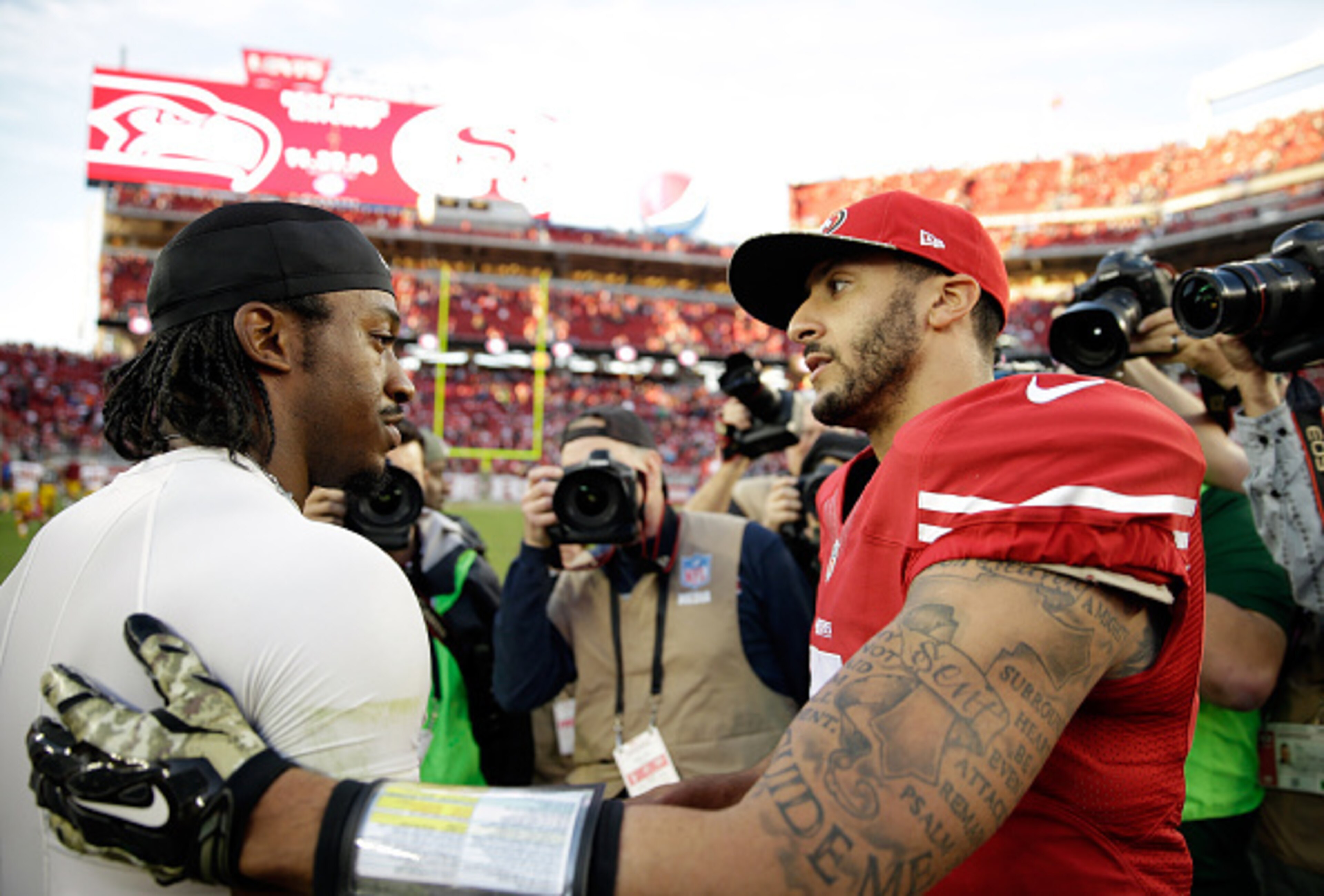 SANTA CLARA, CA - NOVEMBER 23: Colin Kaepernick #7 of the San Francisco 49ers speaks with Robert Griffin III #10 of the Washington Redskins at the conclusion of their game at Levi's Stadium on November 23, 2014 in Santa Clara, California.  (Photo by Ezra 