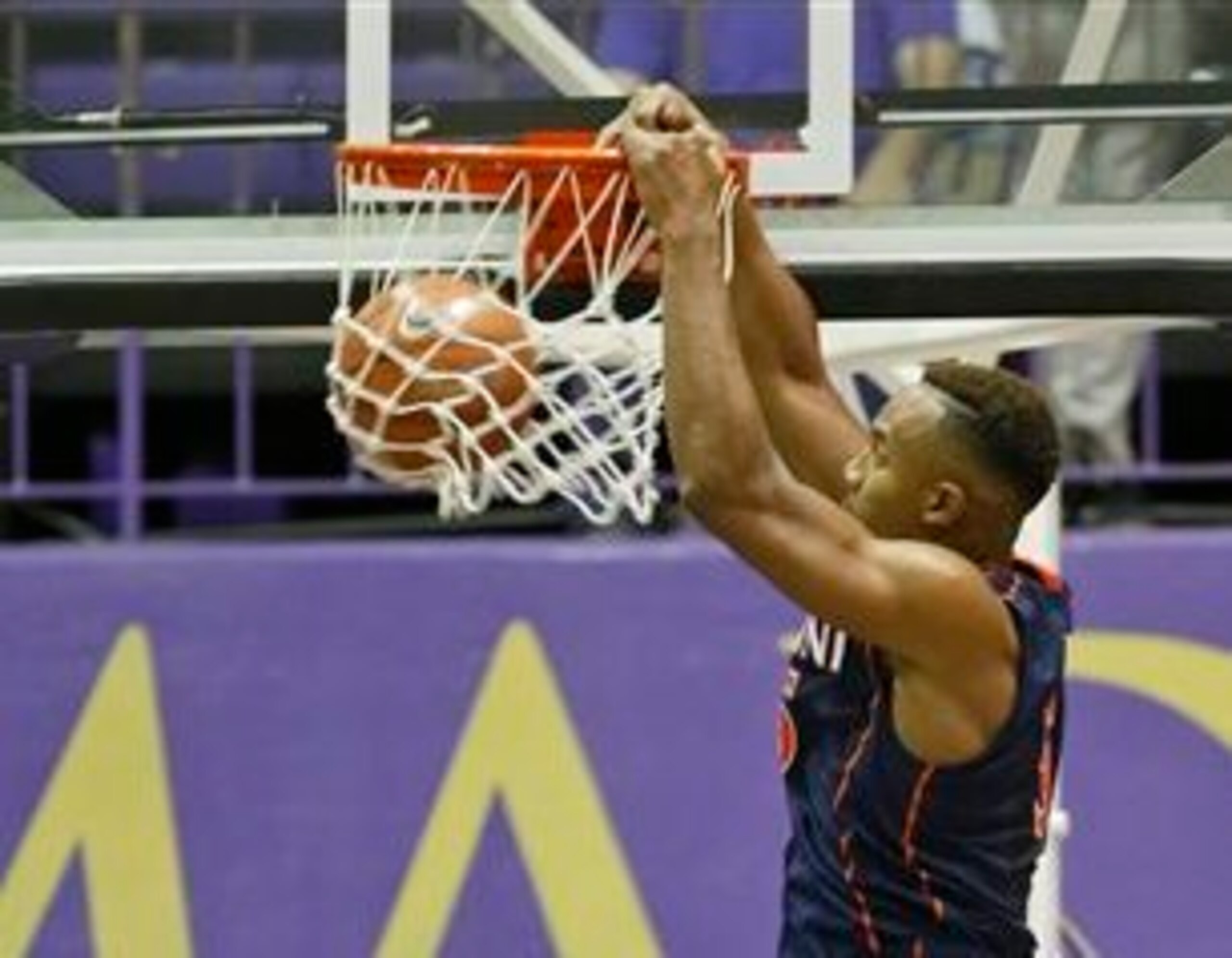 Darion Atkins dunks over a JMU player in the season opener