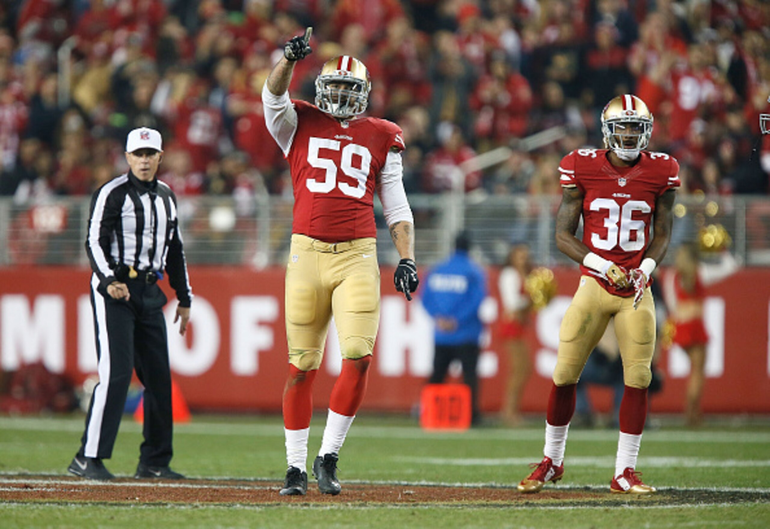 Aaron Lynch (center) totaled one sack and two quarterback hits on Thursday.