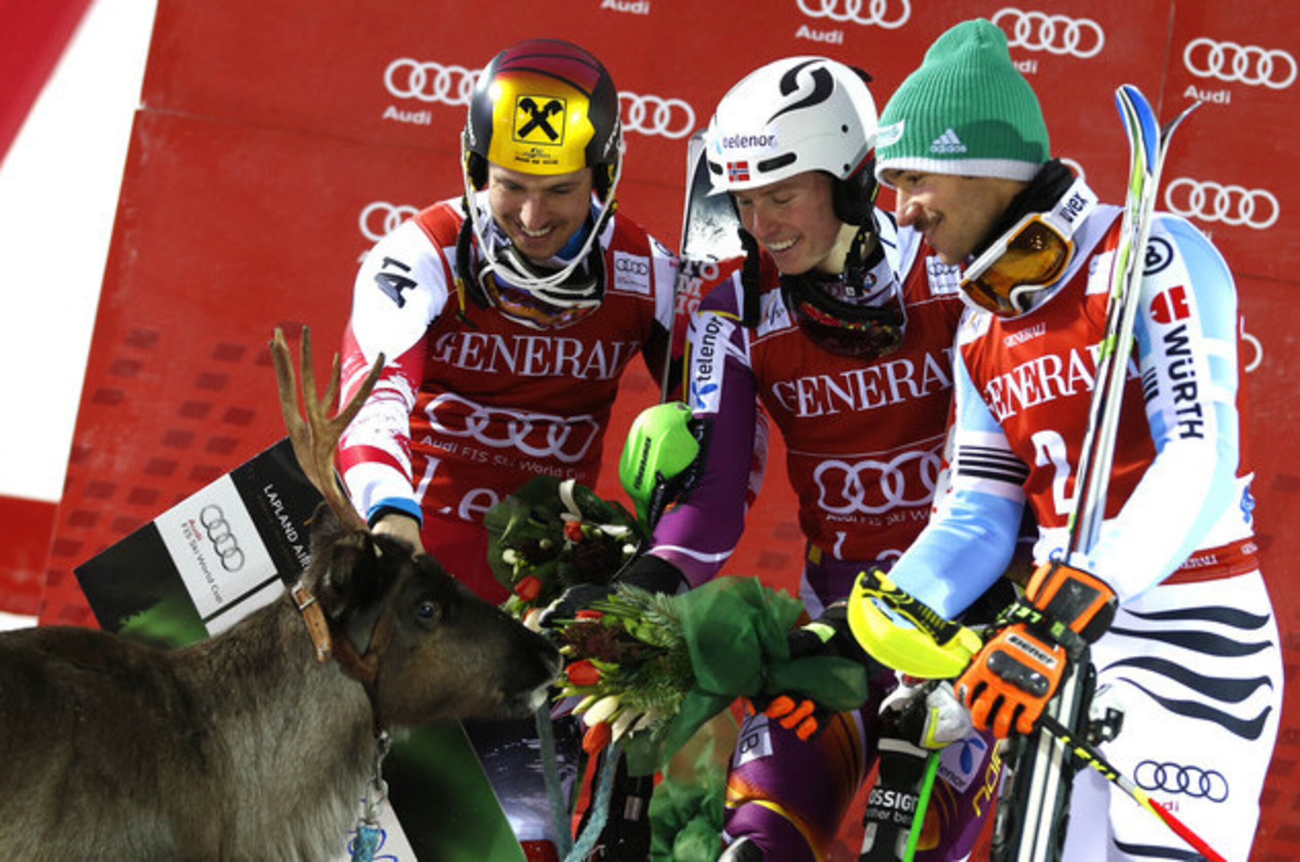Henrik Kristoffersen (centre) meets his new reindeer Lars after winning the Levi slalom race.
