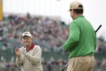 Jack Nicklaus applauds a shot by Tom Watson.