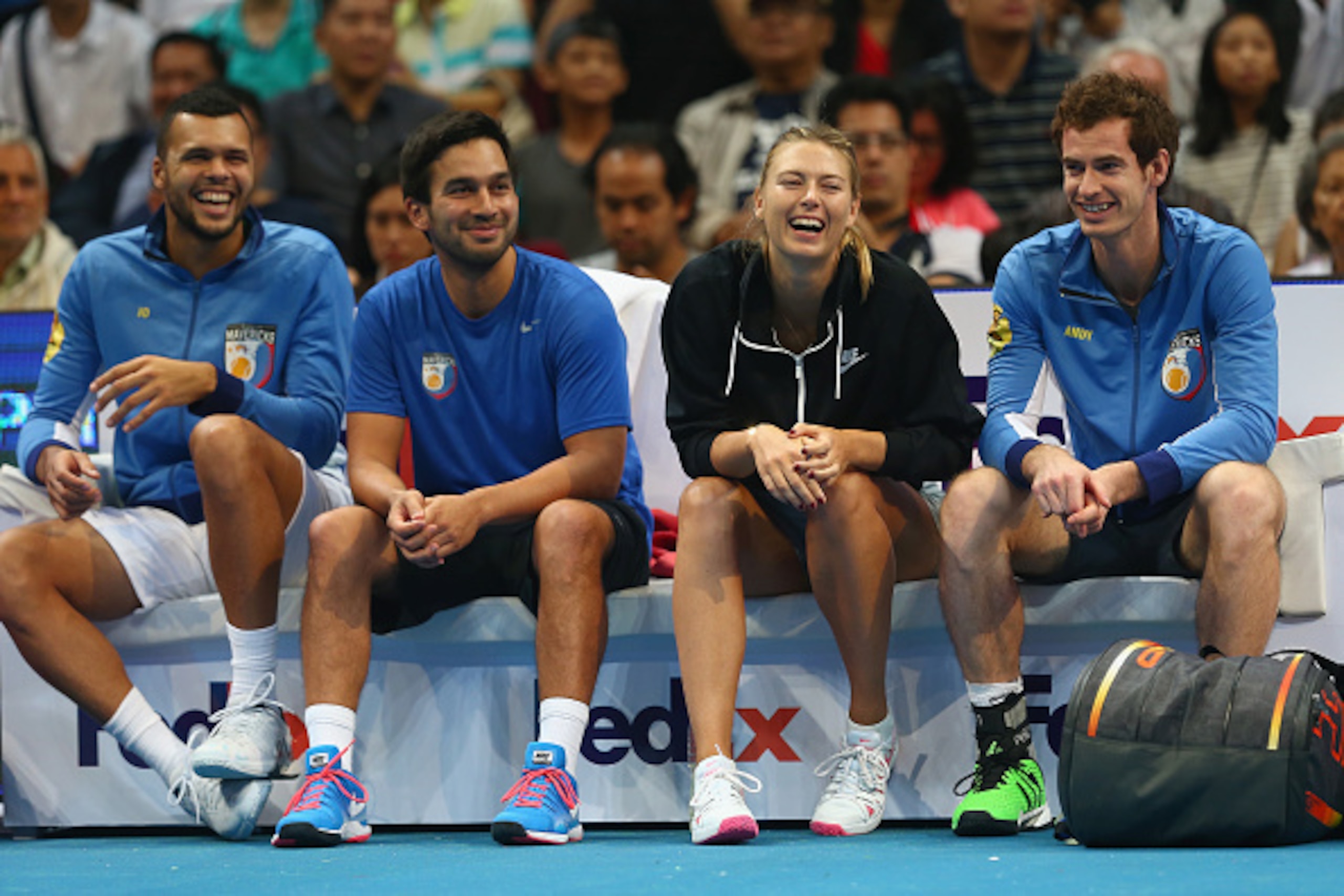Members of the Manila Mavericks enjoy court-side laugh.