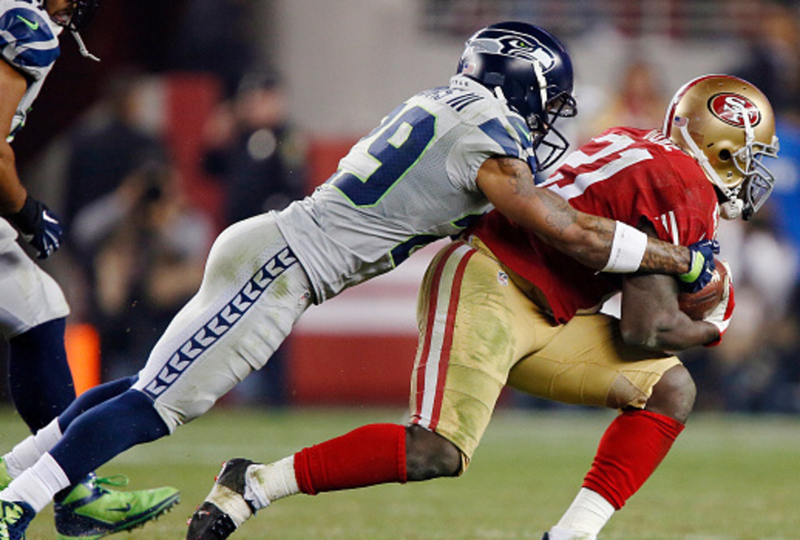 SANTA CLARA, CA - NOVEMBER 27: Free safety Earl Thomas III #29 of the Seattle Seahawks tackles running back Frank Gore #21 of the San Francisco 49ers on an eight-yard gain in the third quarter on November 27, 2014 at Levi's Stadium in Santa Clara, Califo SANTA CLARA, CA - NOVEMBER 27: Free safety Earl Thomas III #29 of the Seattle Seahawks tackles running back Frank Gore #21 of the San Francisco 49ers on an eight-yard gain in the third quarter on November 27, 2014 at Levi's Stadium in Santa Clara, Califo
