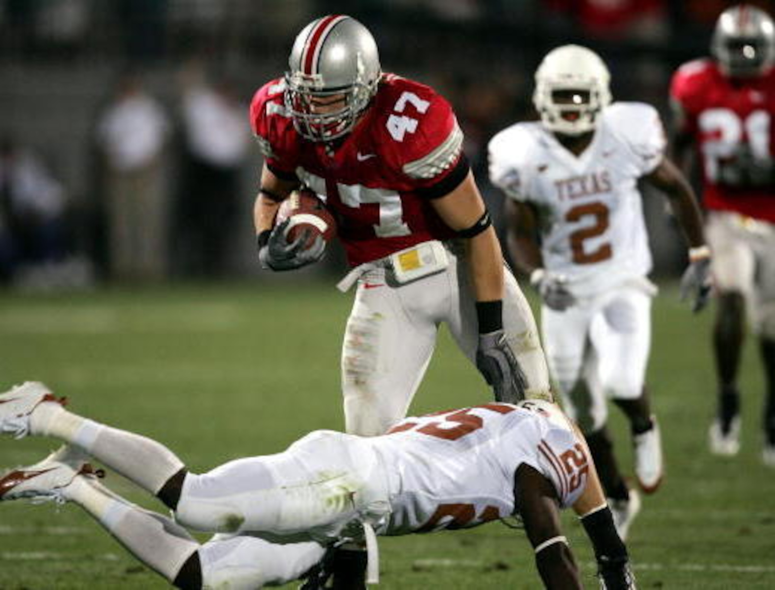 COLUMBUS, OH - SEPTEMBER 10: Linebacker A.J. Hawk #47 of the Ohio State Buckeyes avoids the tackle of wide receiver Mark McCoy #25 of the Texas Longhorns after a fumble recovery during the second quarter at Ohio Stadium on September 10, 2005 in Columbus, COLUMBUS, OH - SEPTEMBER 10: Linebacker A.J. Hawk #47 of the Ohio State Buckeyes avoids the tackle of wide receiver Mark McCoy #25 of the Texas Longhorns after a fumble recovery during the second quarter at Ohio Stadium on September 10, 2005 in Columbus,