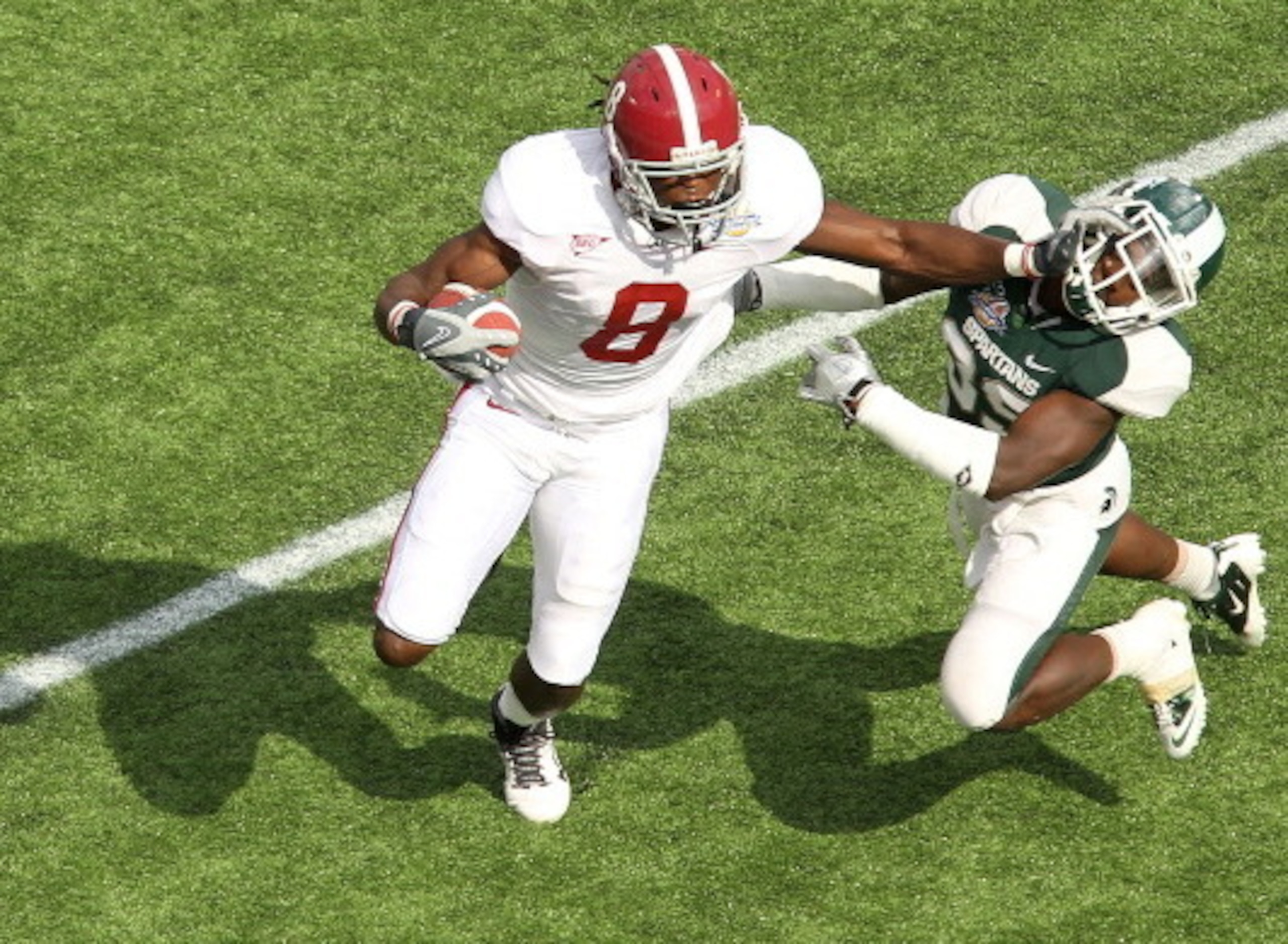 ORLANDO, FL - JANUARY 01: Julio Jones #8 of the Alabama Crimson Tide stiffarms Chris Rucker #29 of the Michigan State Spartans during the Capitol One Bowl at the Florida Citrus Bowl on January 1, 2011 in Orlando, Florida. (Photo by Mike Ehrmann/Getty Im ORLANDO, FL - JANUARY 01: Julio Jones #8 of the Alabama Crimson Tide stiffarms Chris Rucker #29 of the Michigan State Spartans during the Capitol One Bowl at the Florida Citrus Bowl on January 1, 2011 in Orlando, Florida. (Photo by Mike Ehrmann/Getty Im