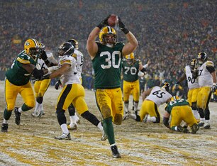 John Kuhn found the end zone in the snow.