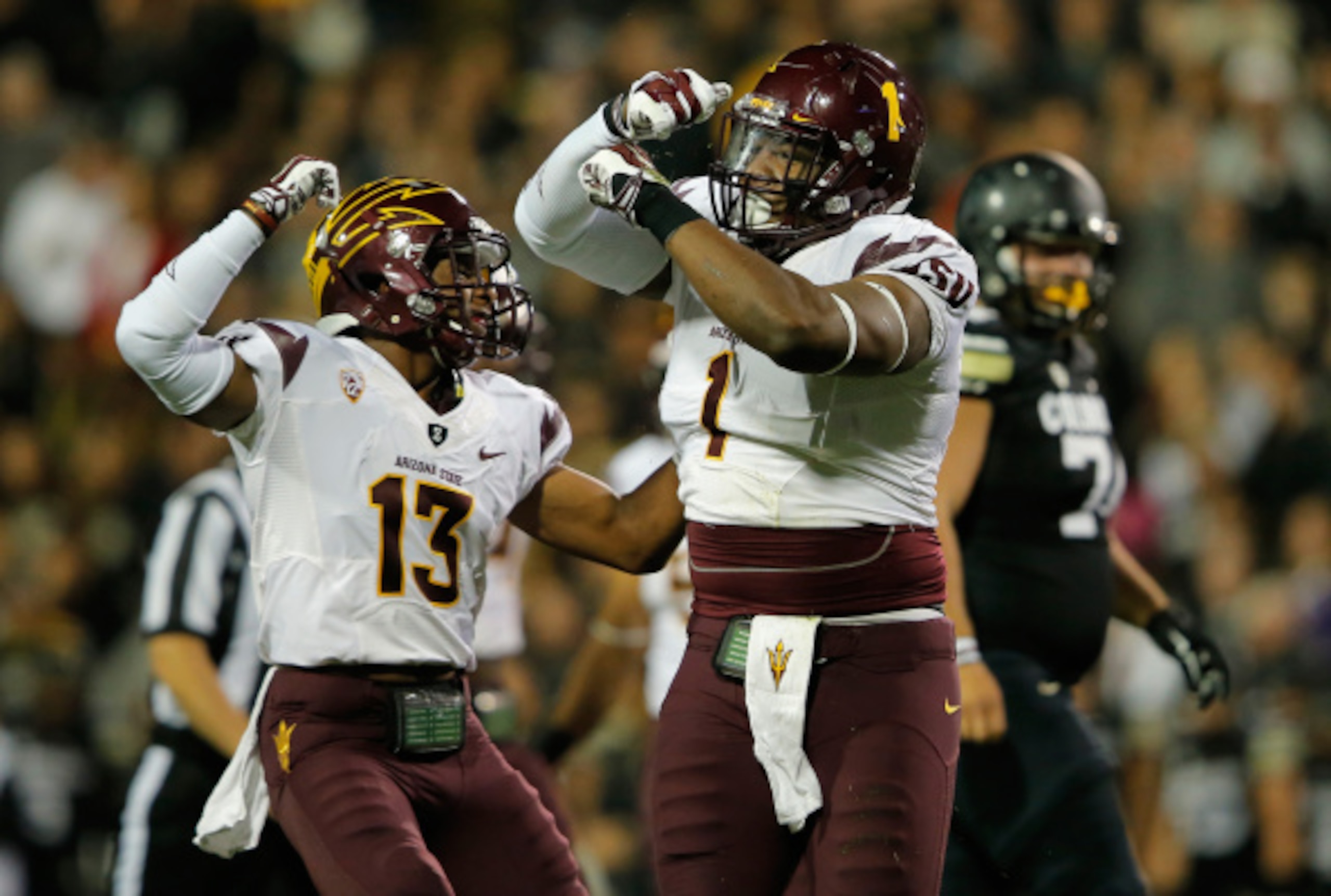 Marcus Hardison (No. 1) celebrates a big play against Colorado.