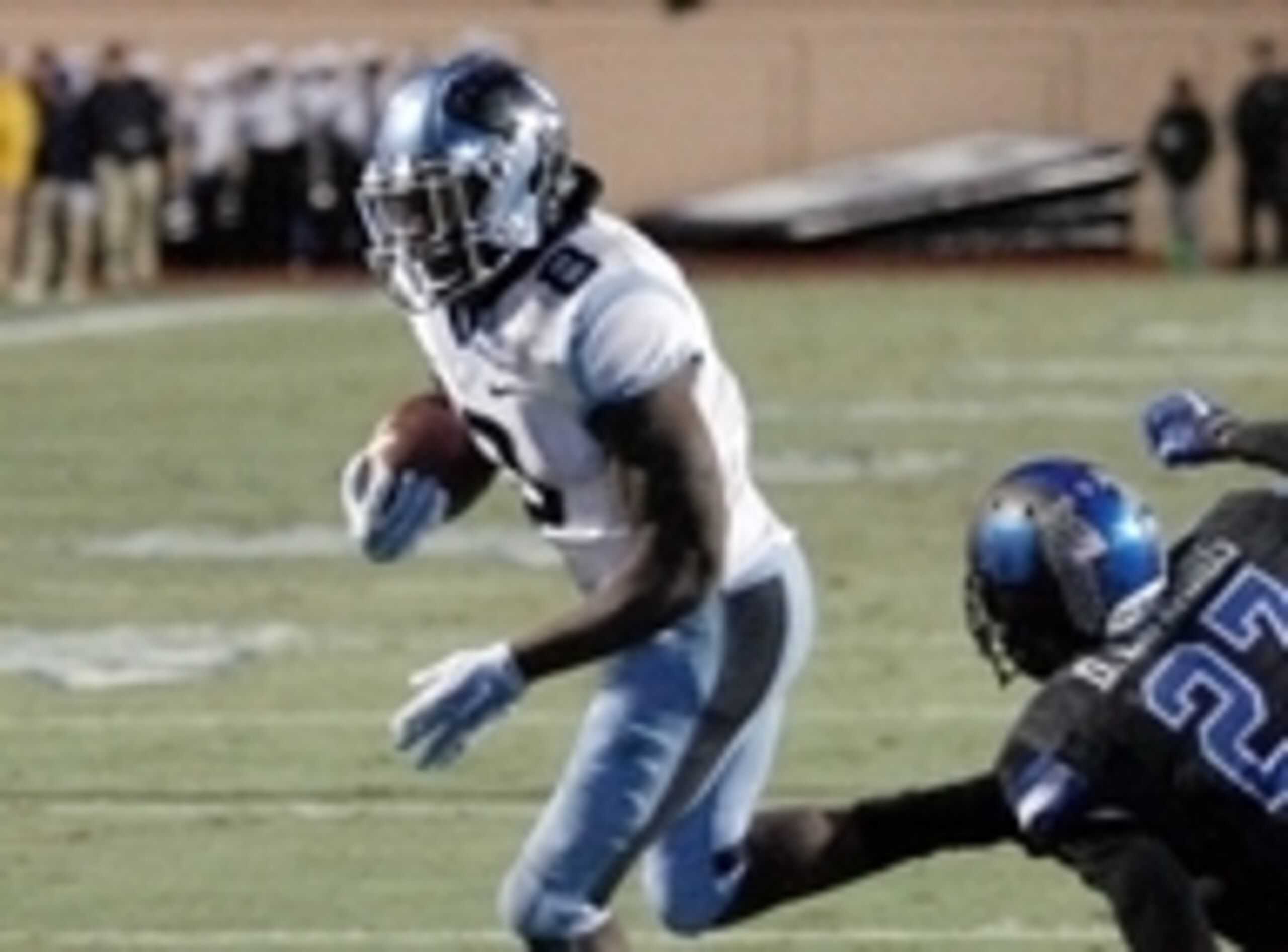 Nov 20, 2014; Durham, NC, USA; North Carolina Tar Heels running back T.J. Logan (8) runs the ball against Duke Blue Devils safety DeVon Edwards (27) in their game at Wallace Wade Stadium. Mandatory Credit: Mark Dolejs-USA TODAY Sports