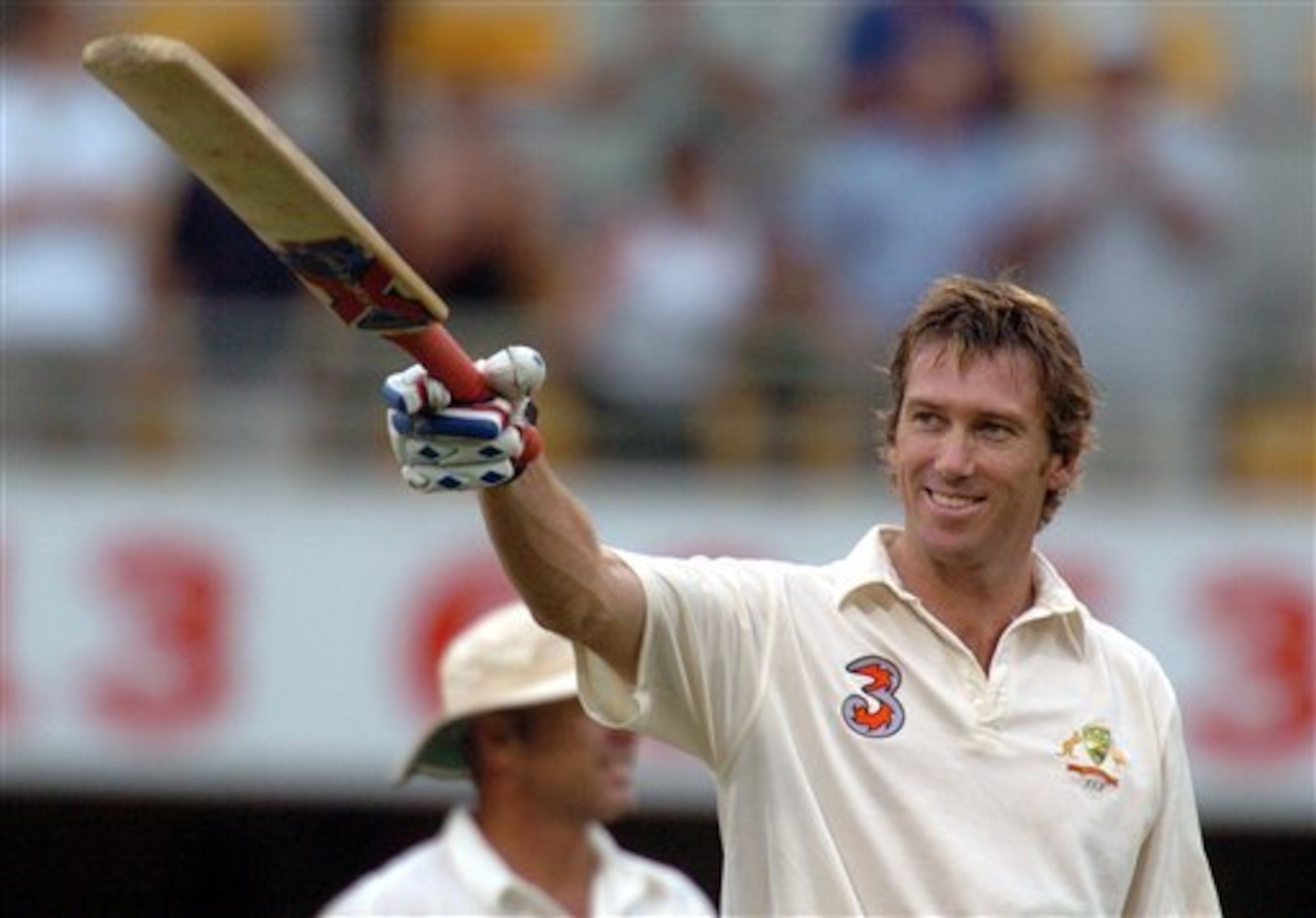 Australian batsman Glenn McGrath waves his bat to the crowd after 54 no out at the end of play on the third day of play of the first Test match between Australia and New Zealand at the Gabba, Brisbane, Saturday Nov 20, 2004. Australia finish at 9 for 564 