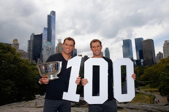 NEW YORK, NY - SEPTEMBER 08:  (L) Bob Bryan and (R) Mike Bryan of United States pose with the US Open men's doubles champions trophy in Central Park during their New York City media tour after winning their 100th career title on September 8, 2014 in New Y
