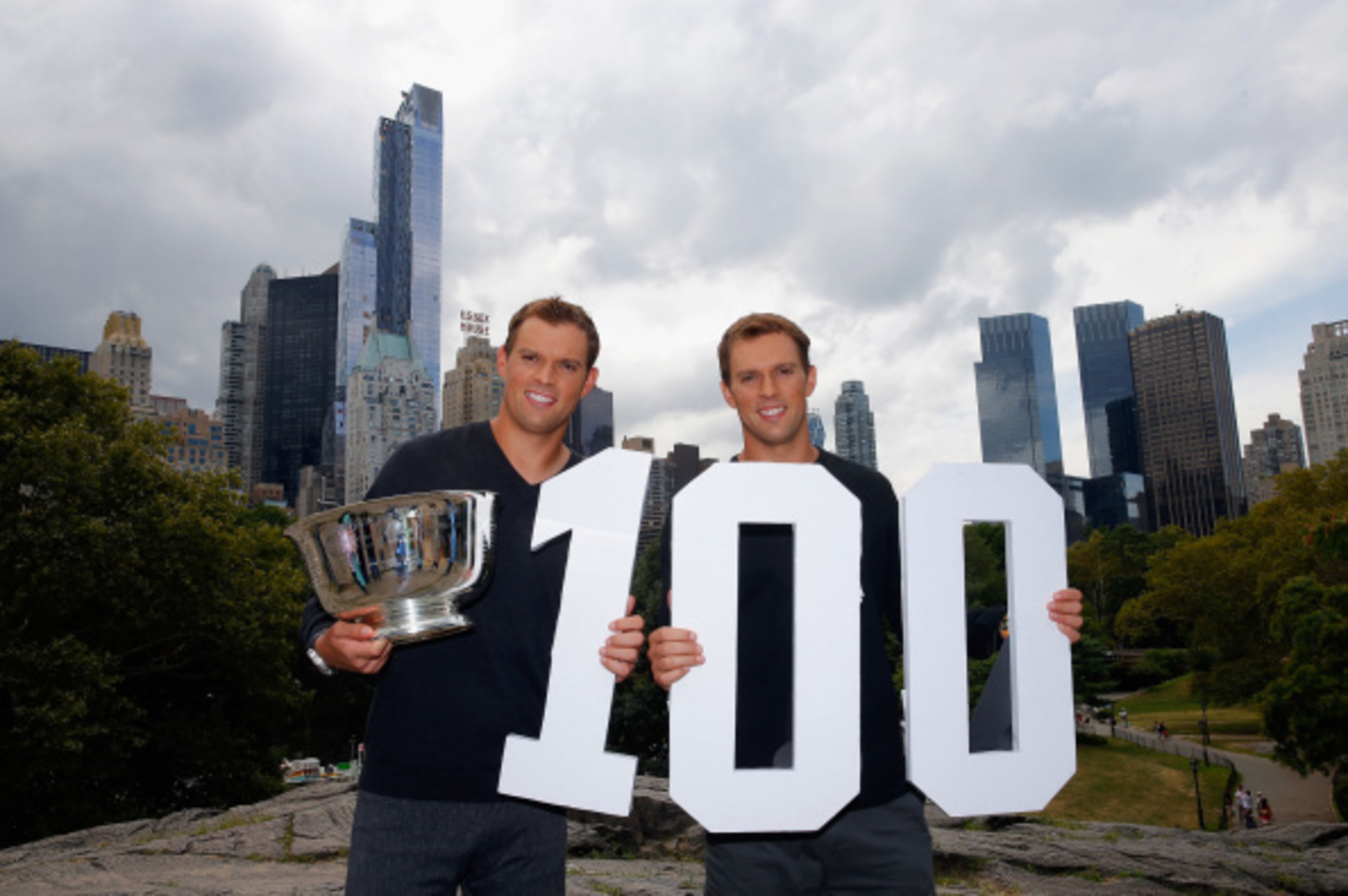 NEW YORK, NY - SEPTEMBER 08:  (L) Bob Bryan and (R) Mike Bryan of United States pose with the US Open men's doubles champions trophy in Central Park during their New York City media tour after winning their 100th career title on September 8, 2014 in New Y