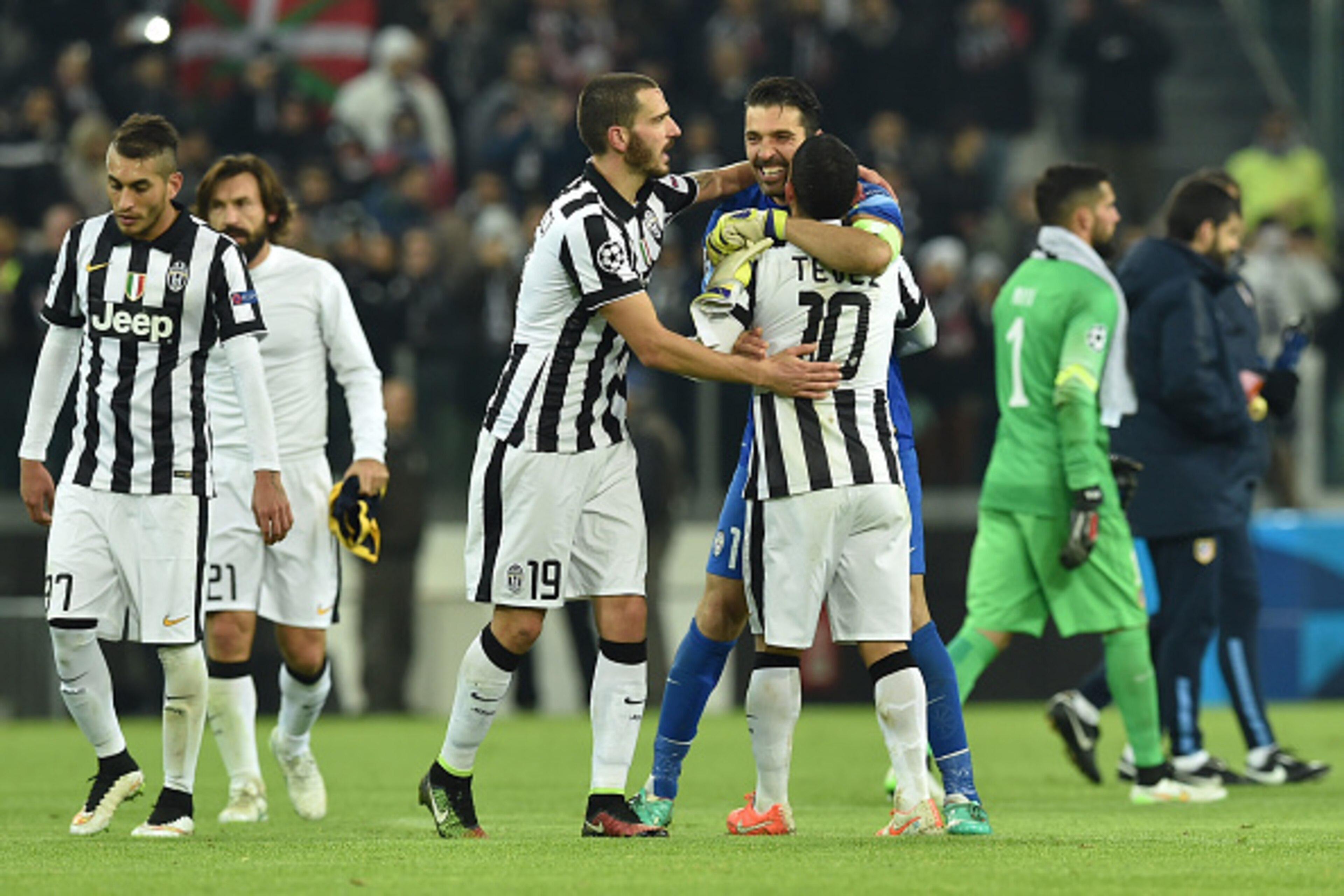 Leonardo Bonucci, Gianluigi Buffon and Carlos Tevez celebrate their progression to the Champions League knockout stage.