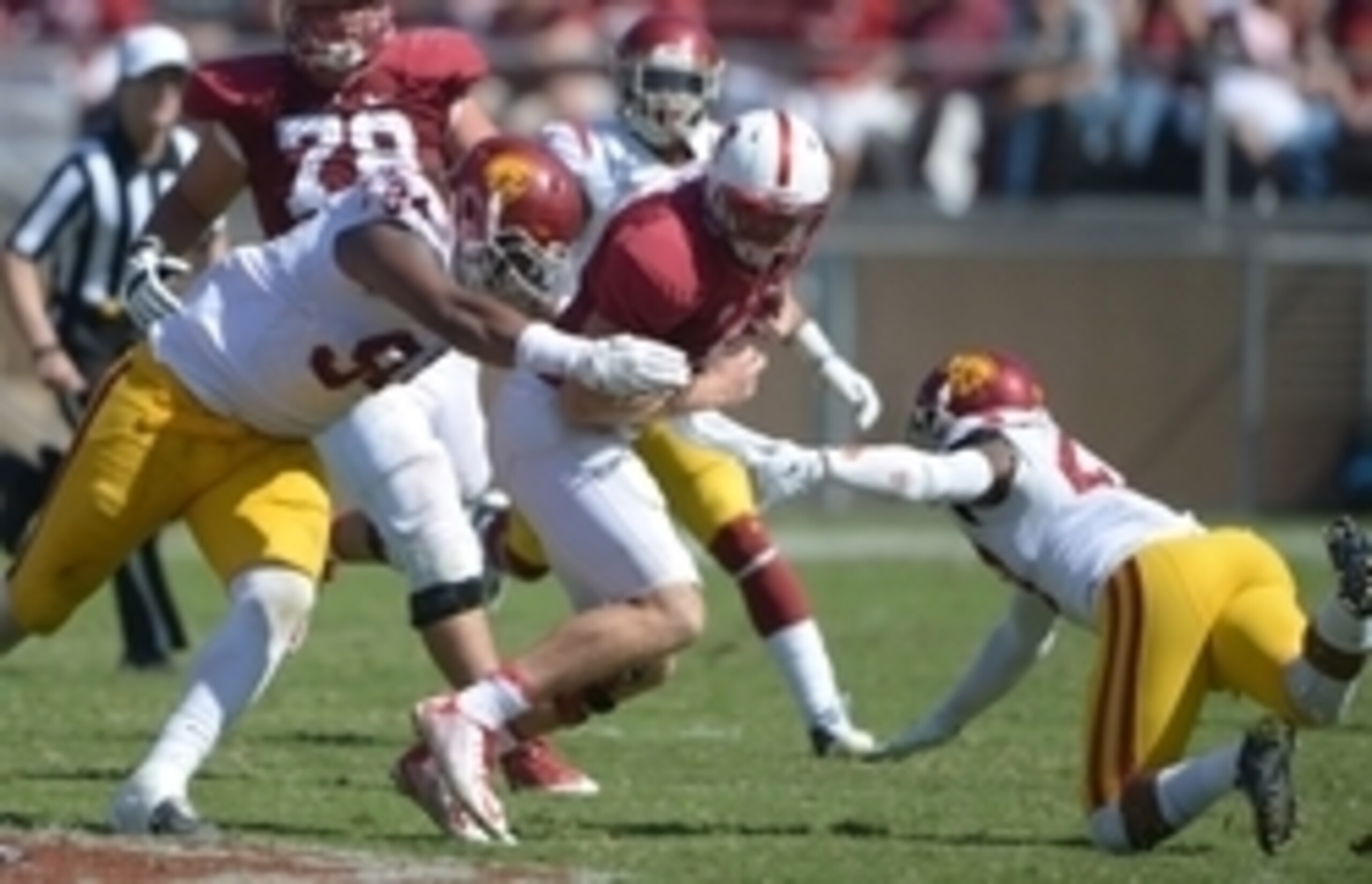 Sep 6, 2014; Stanford, CA, USA; Stanford Cardinal quarterback Kevin Hogan (8) is pressured by Southern California Trojans defensive end Leonard Williams (94) and safety Gerald Bowman (27) at Stanford Stadium. USC defeated Stanford 13-10. Mandatory Credit: