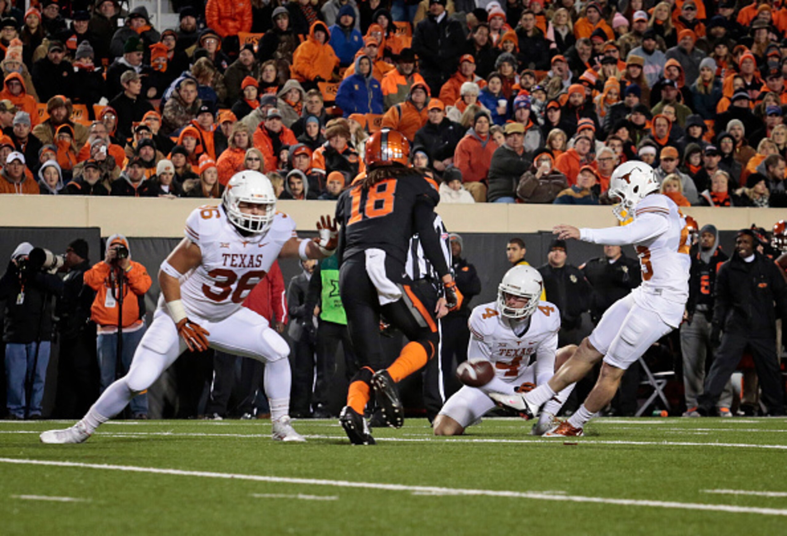 STILLWATER, OK - NOVEMBER 15:   Place kicker Nick Rose #23 of the Texas Longhorns kicks an extra point against the Oklahoma State Cowboys November 15, 2014 at Boone Pickens Stadium in Stillwater, Oklahoma. The Longhorns defeated the Cowboys 28-7.  (Photo 
