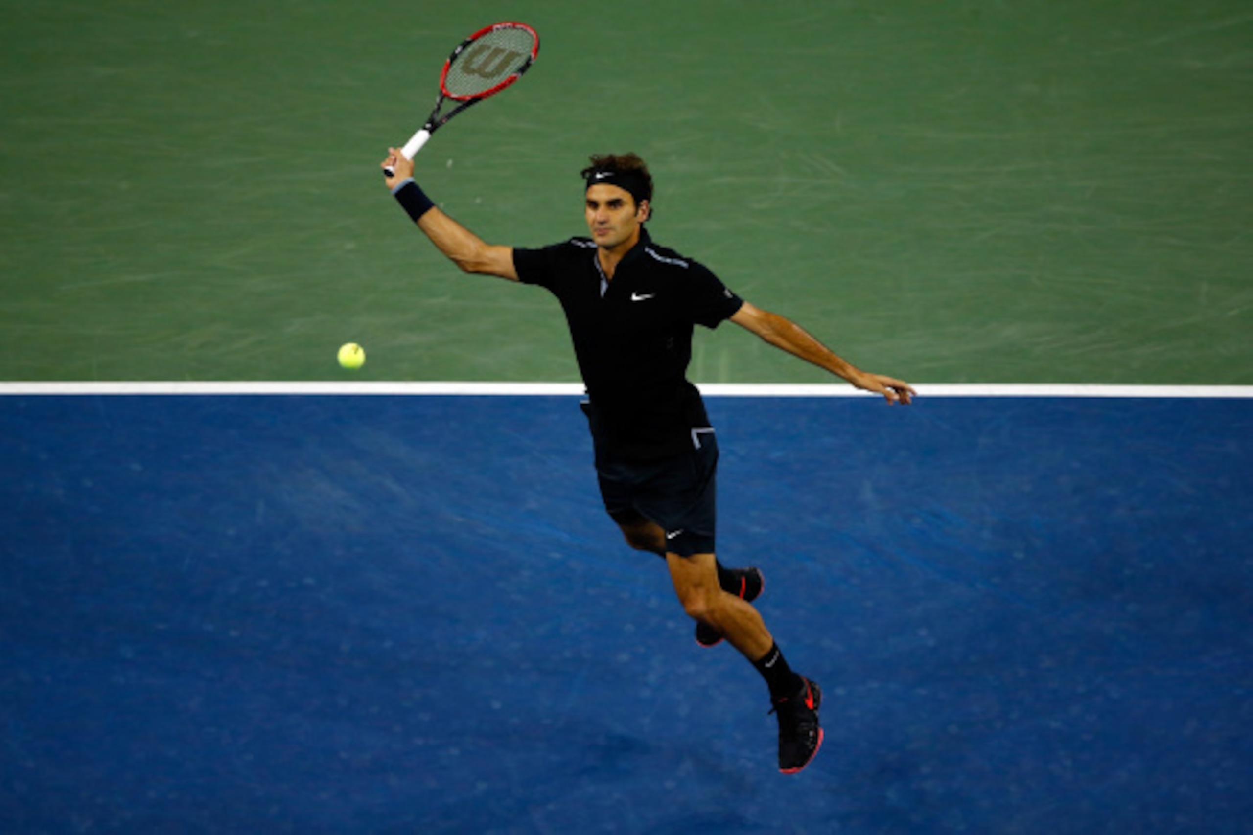 Roger Federer flies into a shot at the 2014 U.S. Open.
