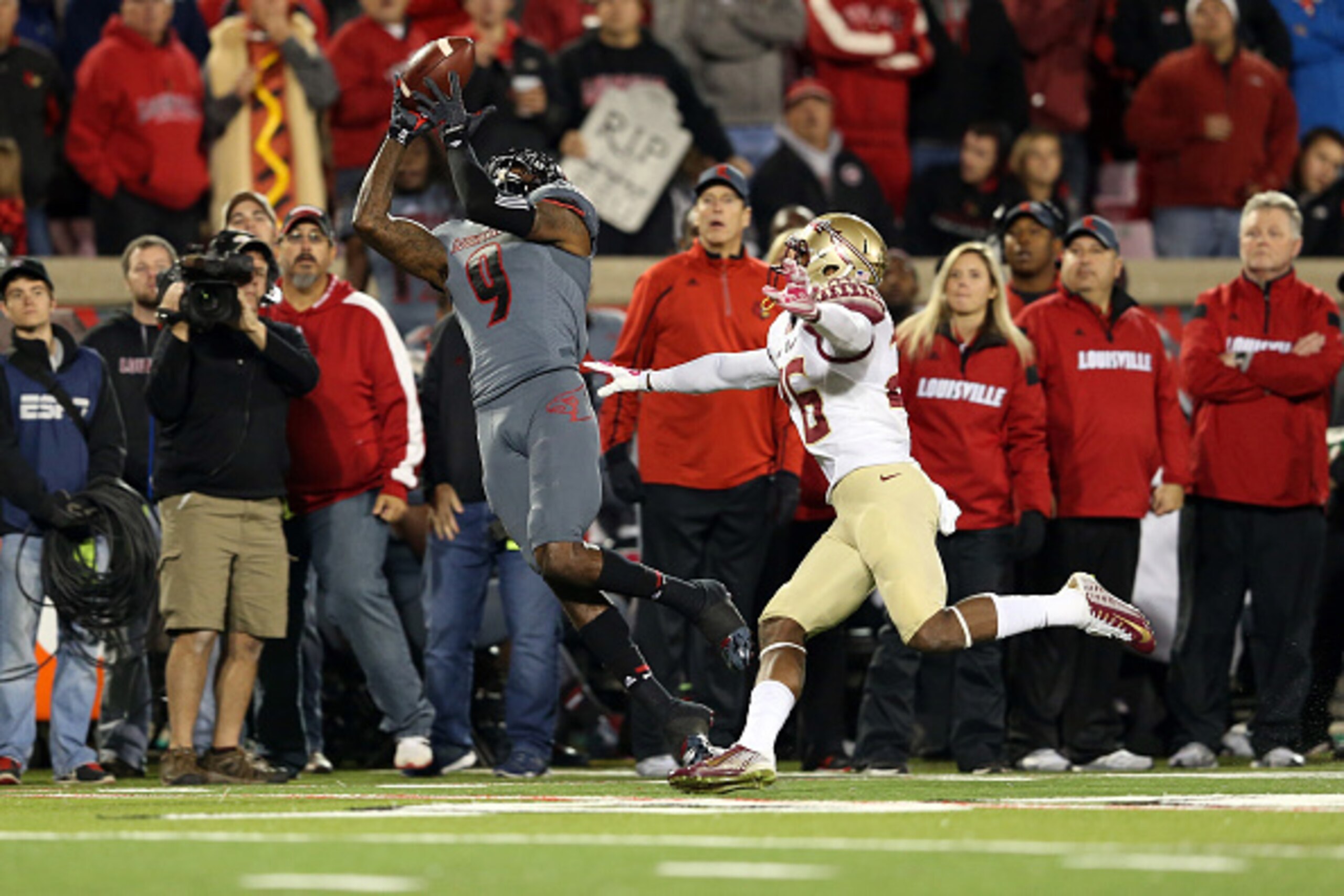 Louisville's DeVante Parker (No. 9) high-points a catch on the sideline against defending national champion Florida St.