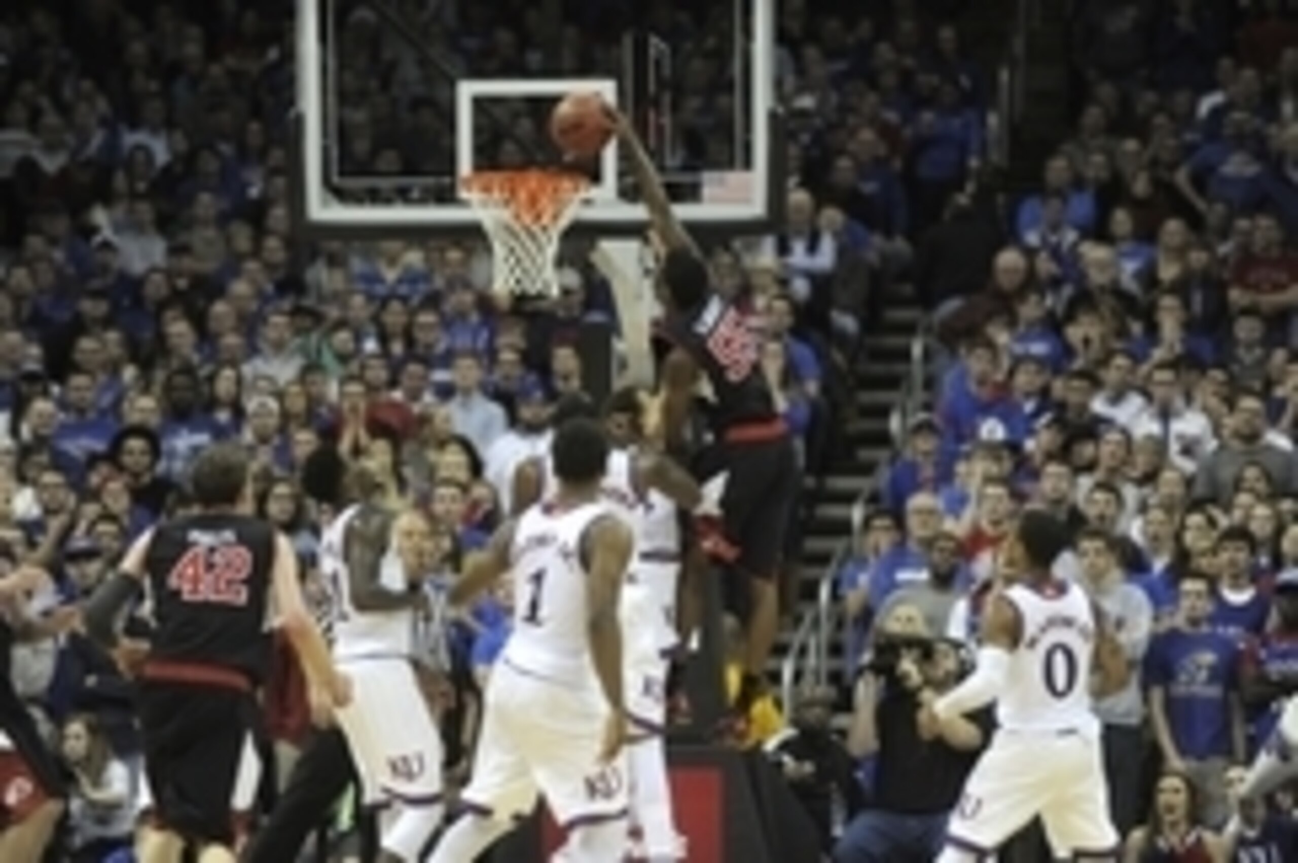 Delon Wright of Utah goes in for a dunk