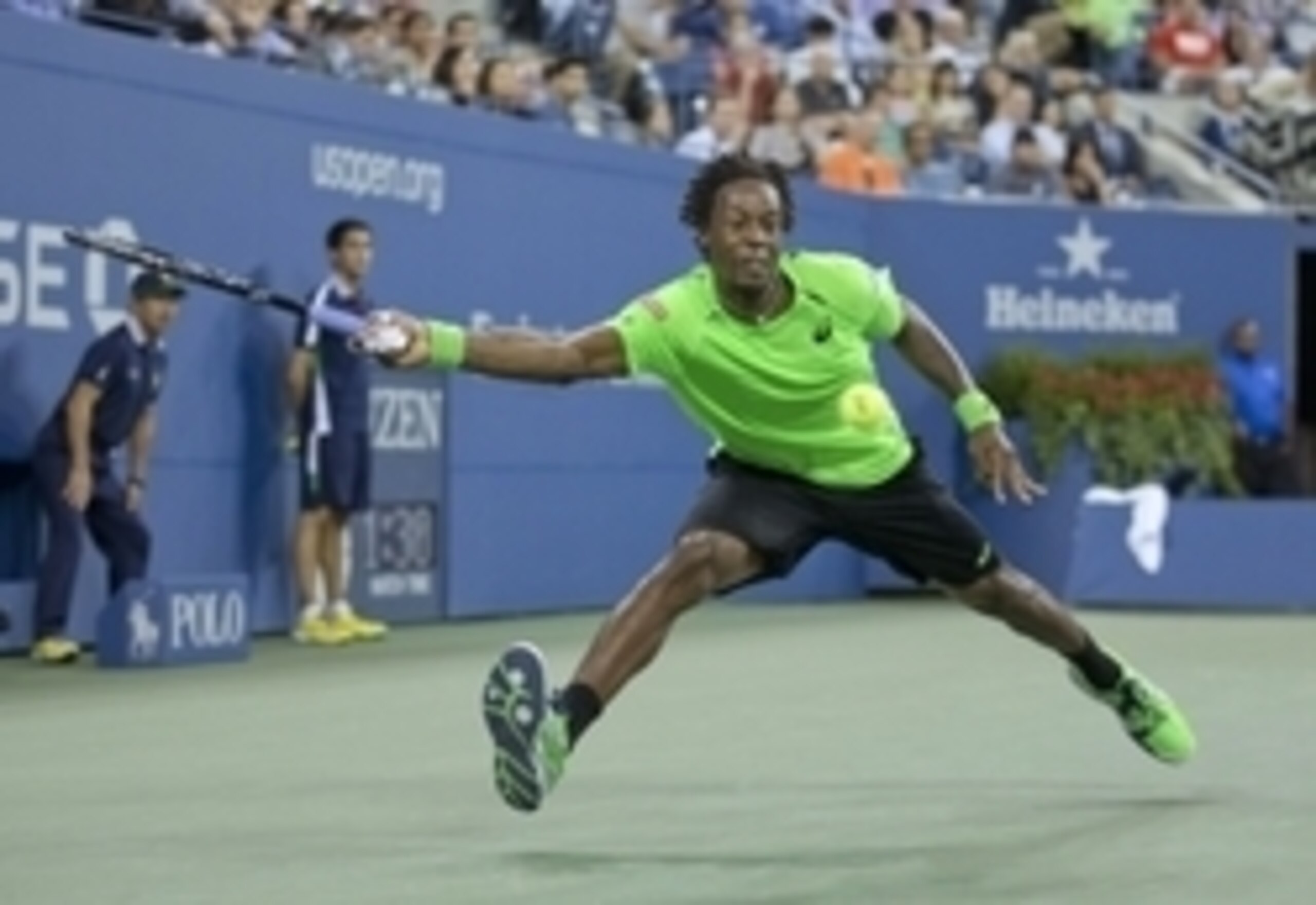 Gael Monfils stretches to make a play on the ball during a match at the 2014 U.S. Open.