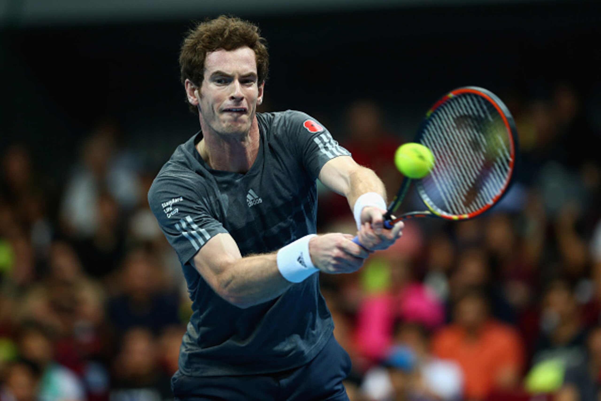 Andy Murray hits a backhand during an IPTL event.