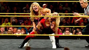 Charlotte withstands the punishment being dished out by Natalya.