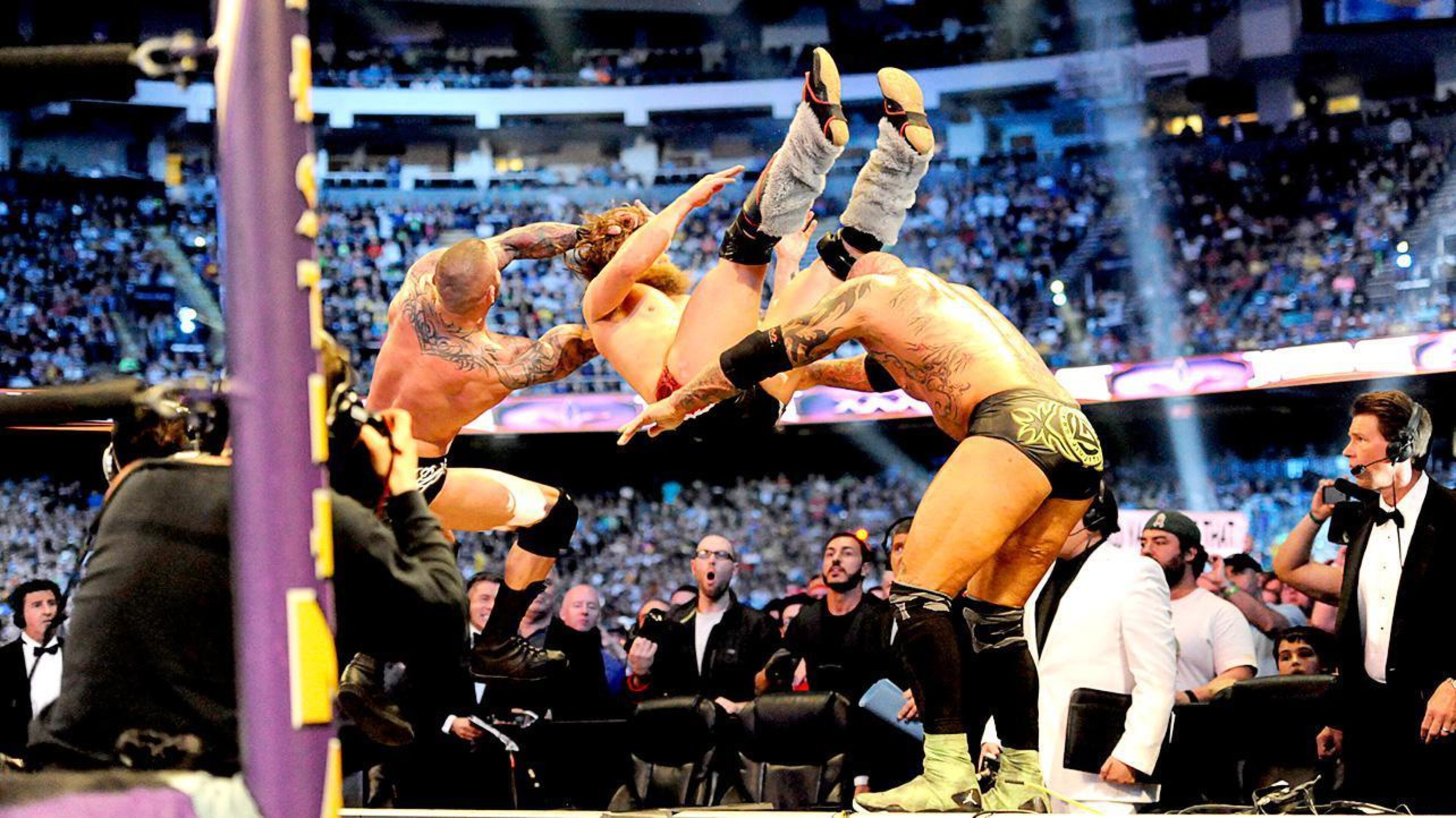 Randy Orton and Batista double team Daniel Bryan. Randy Orton and Batista double team Daniel Bryan.