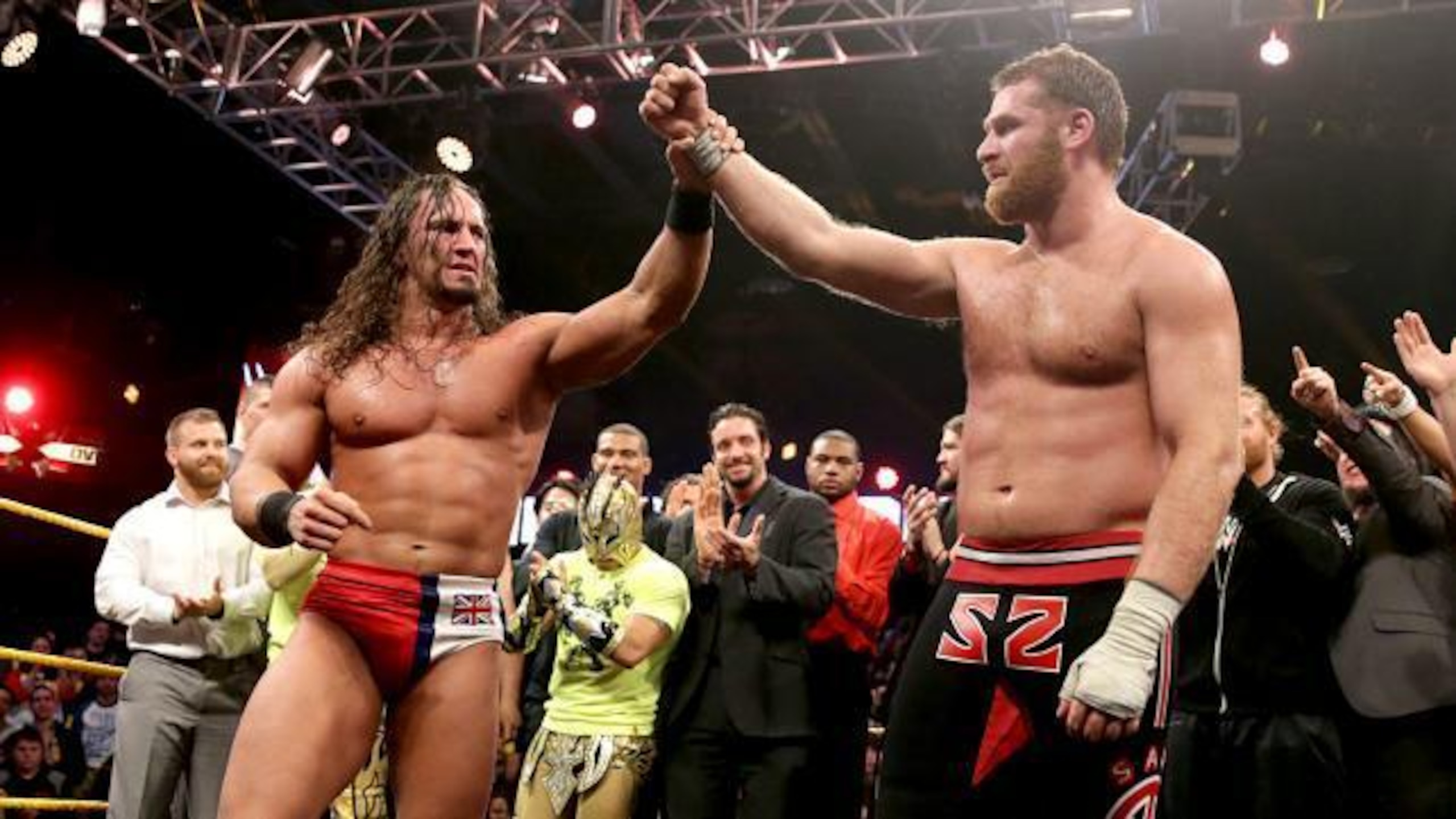 Adrian Neville and Sami Zayn embrace each other after their epic encounter.