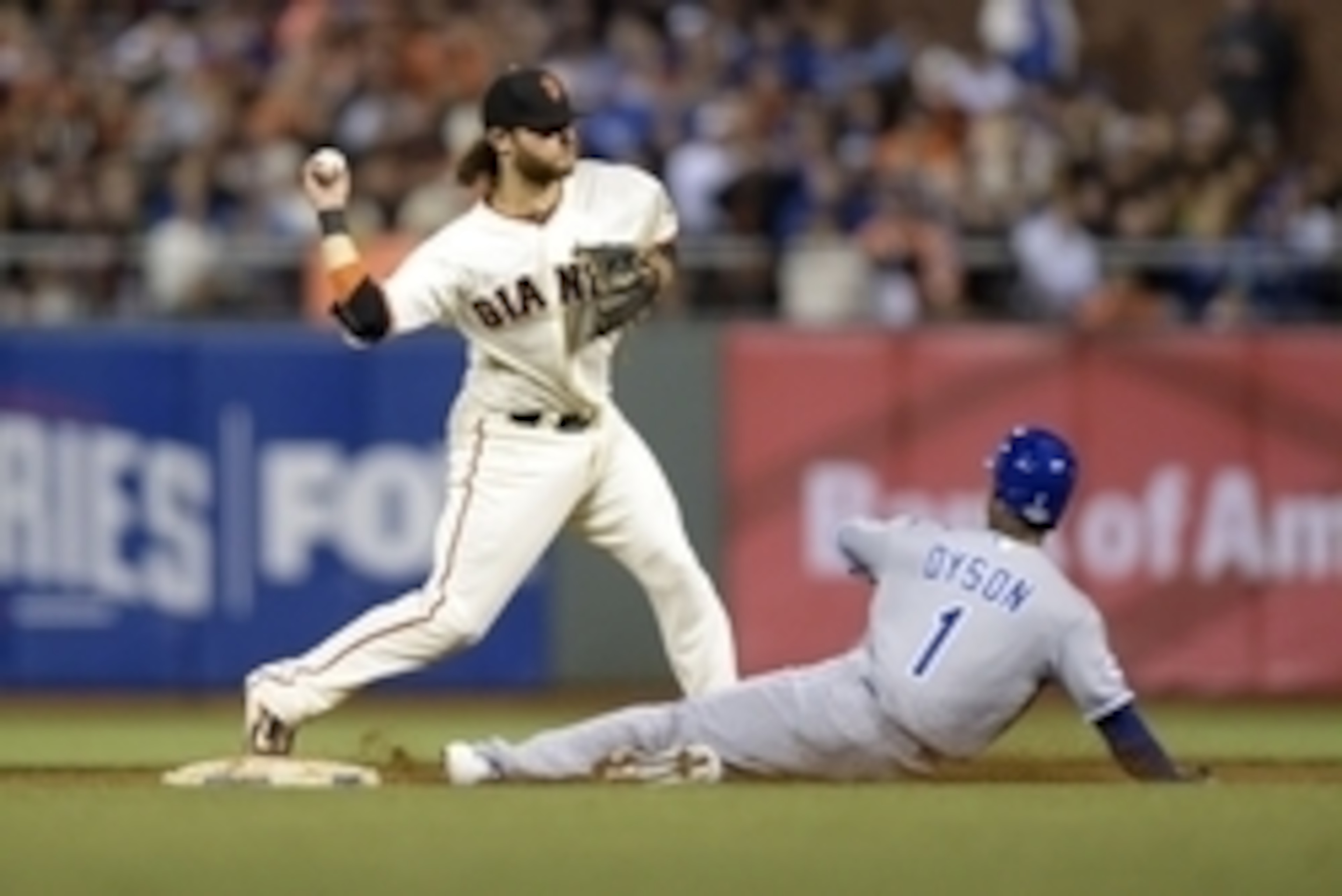 Brandon Crawford turns a double play against the Royals.