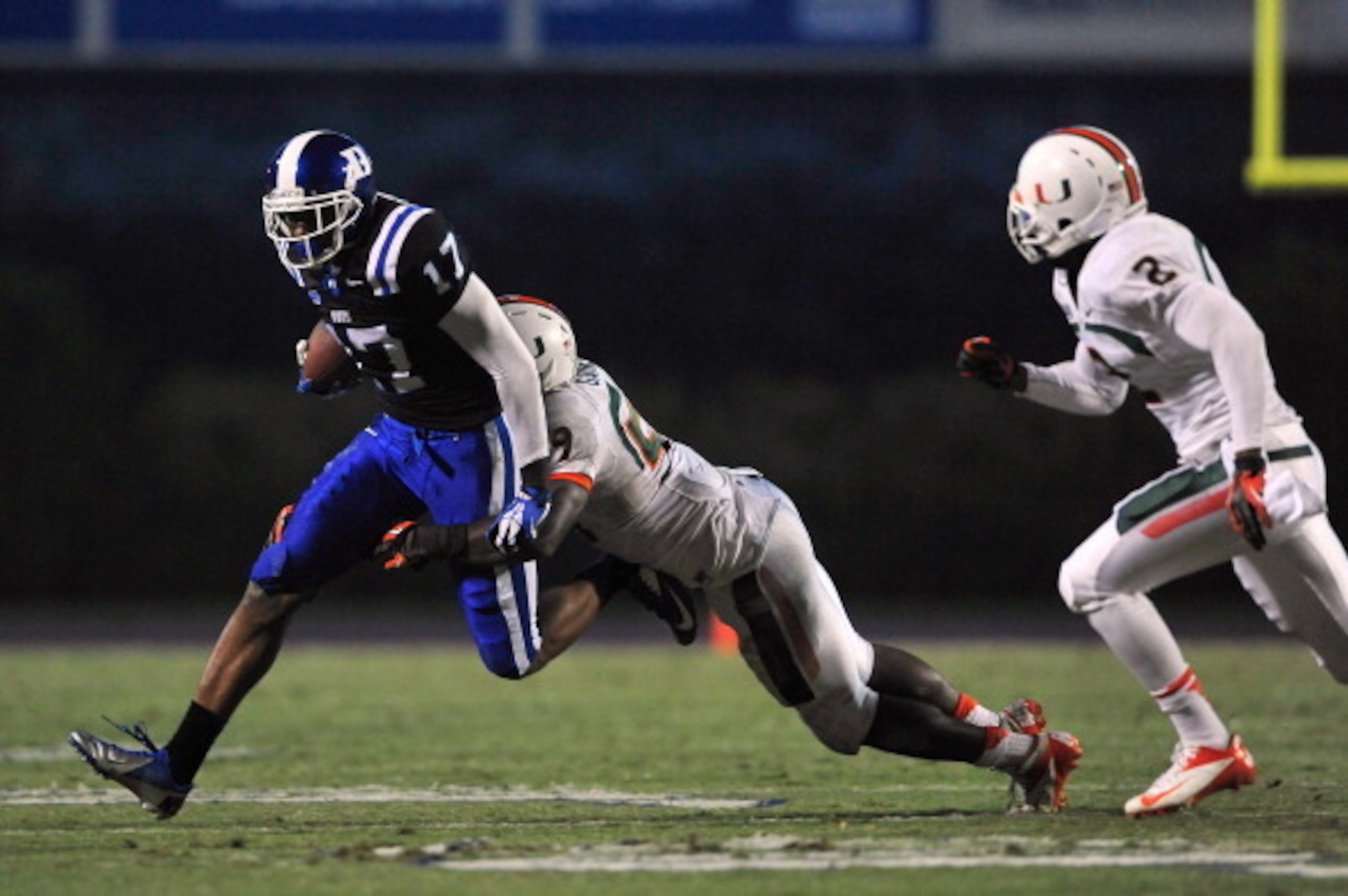 DURHAM, NC - NOVEMBER 16:  Jimmy Gaines #59 of the Miami Hurricanes tackles Isaac Blakeney #17 of the Duke Blue Devils during play at Wallace Wade Stadium on November 16, 2013 in Durham, North Carolina. Duke won 48-30.  (Photo by Grant Halverson/Getty Ima