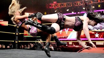 Paige lands a devastating dropkick on Emma.