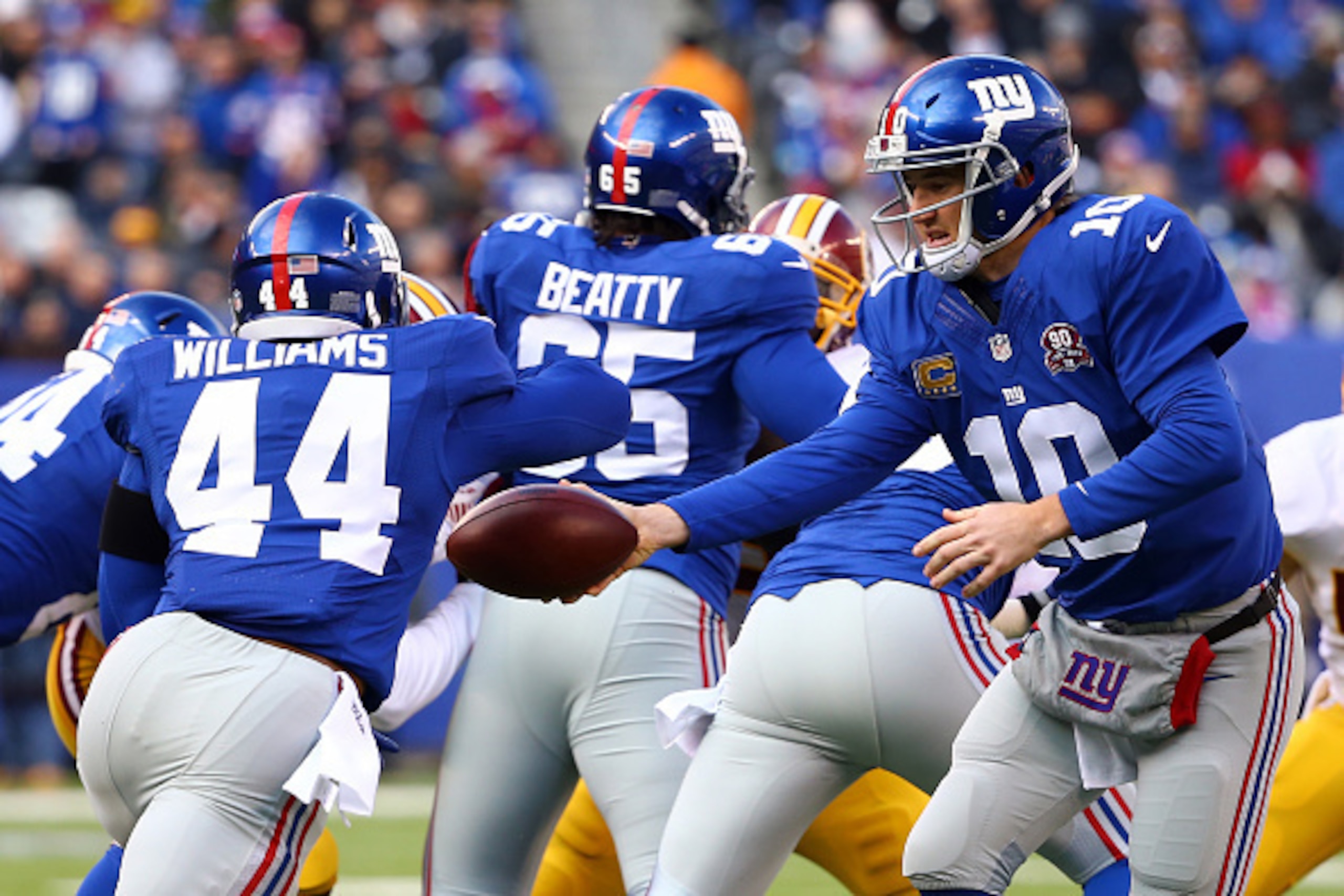 Eli Manning hands off to Andre Williams. Eli Manning hands off to Andre Williams.