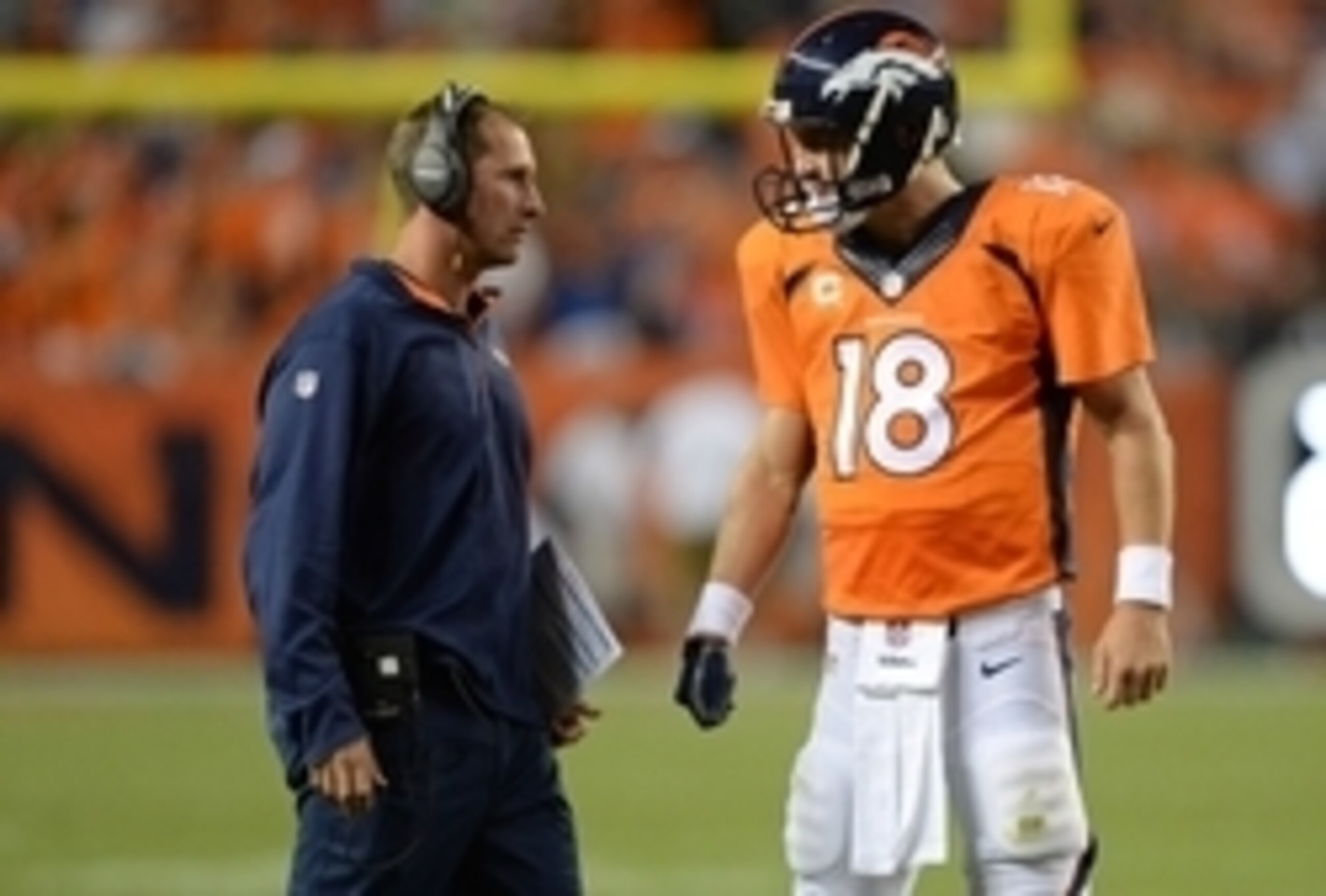 Adam Gase discusses strategy with Peyton Manning.