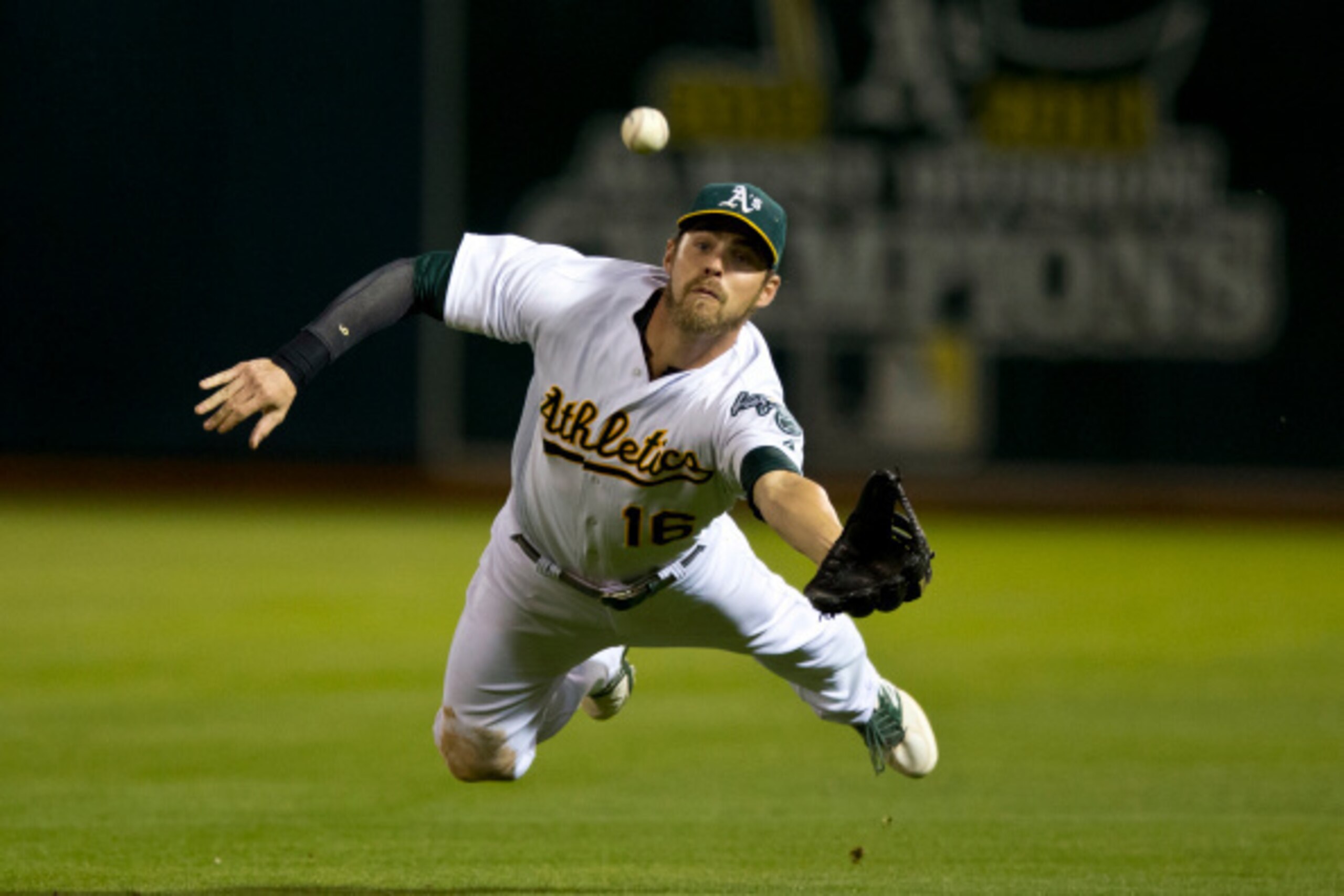 OAKLAND, CA - AUGUST 05:  Josh Reddick #16 of the Oakland Athletics catches and then drops a fly ball hit off the bat of Evan Longoria (not pictured) of the Tampa Bay Rays for a single during the fifth inning at O.co Coliseum on August 5, 2014 in Oakland,
