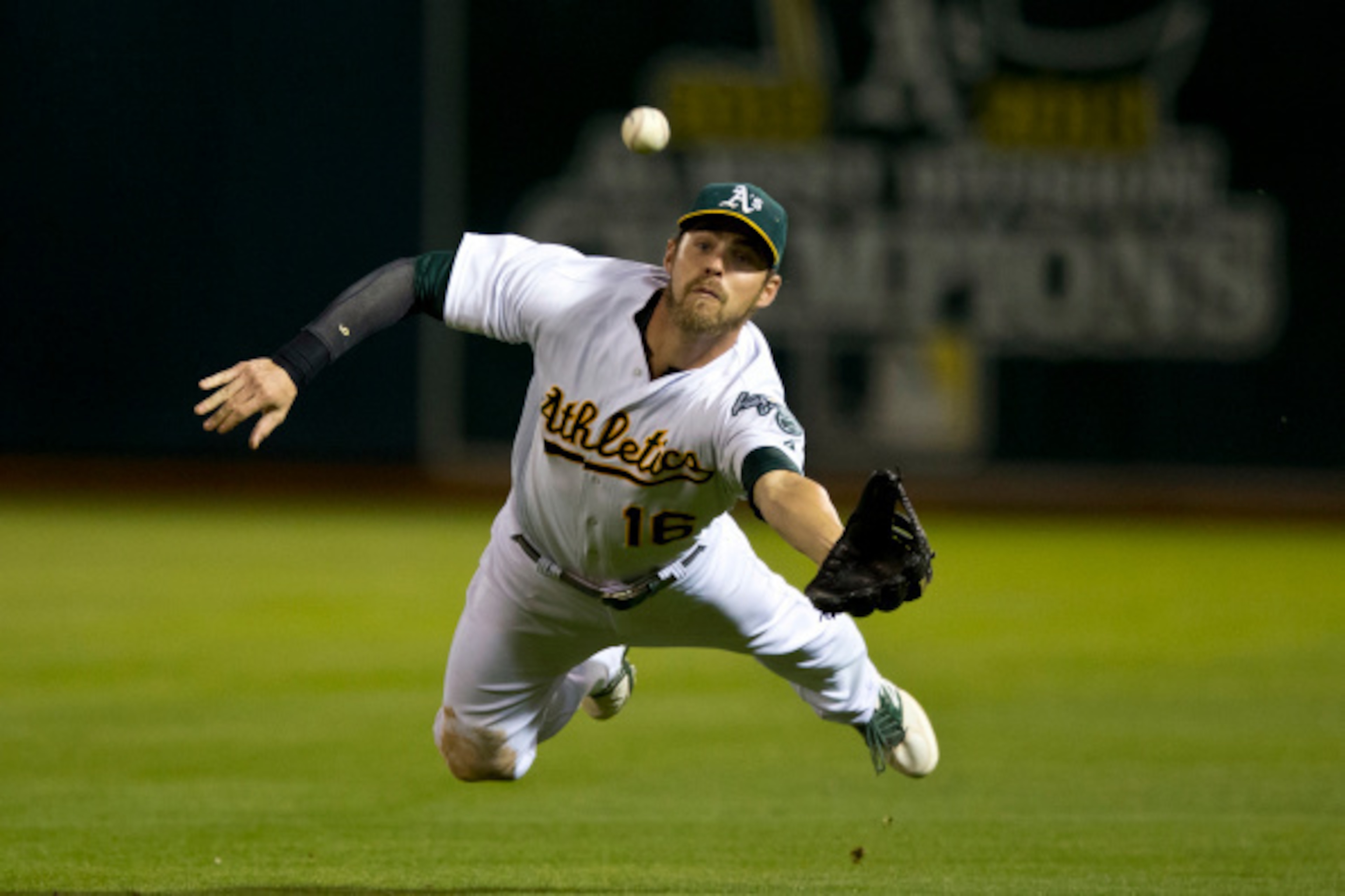 OAKLAND, CA - AUGUST 05:  Josh Reddick #16 of the Oakland Athletics catches and then drops a fly ball hit off the bat of Evan Longoria (not pictured) of the Tampa Bay Rays for a single during the fifth inning at O.co Coliseum on August 5, 2014 in Oakland,